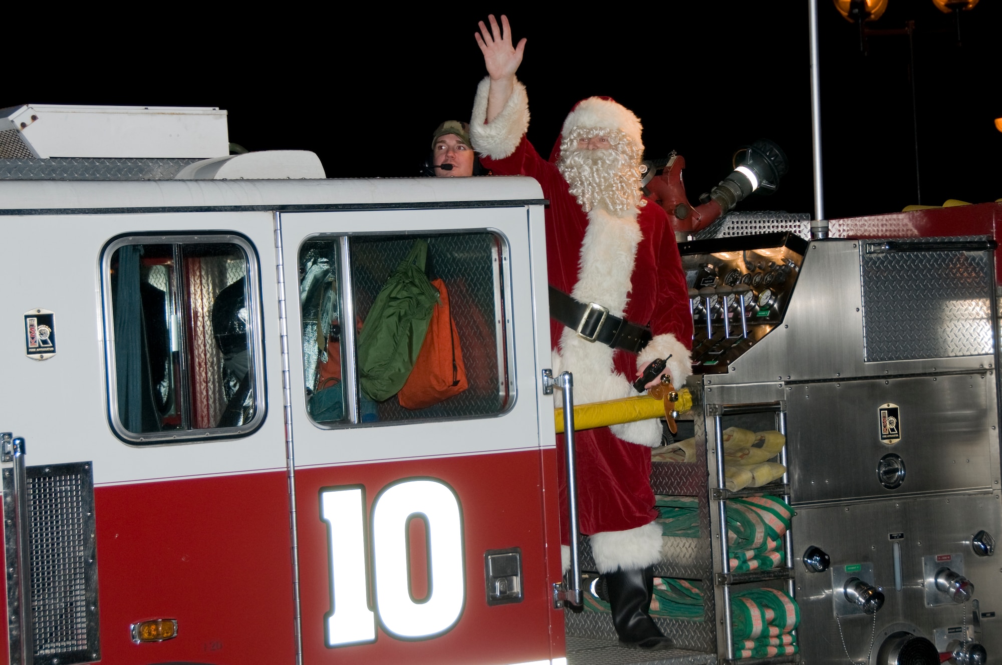 Santa Claus arrives on RAF Lakenheath Fire department's Engine 10 to meet the children and see what they want for Christmas Dec. 5 at RAF Lakenheath, England. (U.S. Air Force photo by Airman 1st Class Perry Aston) 