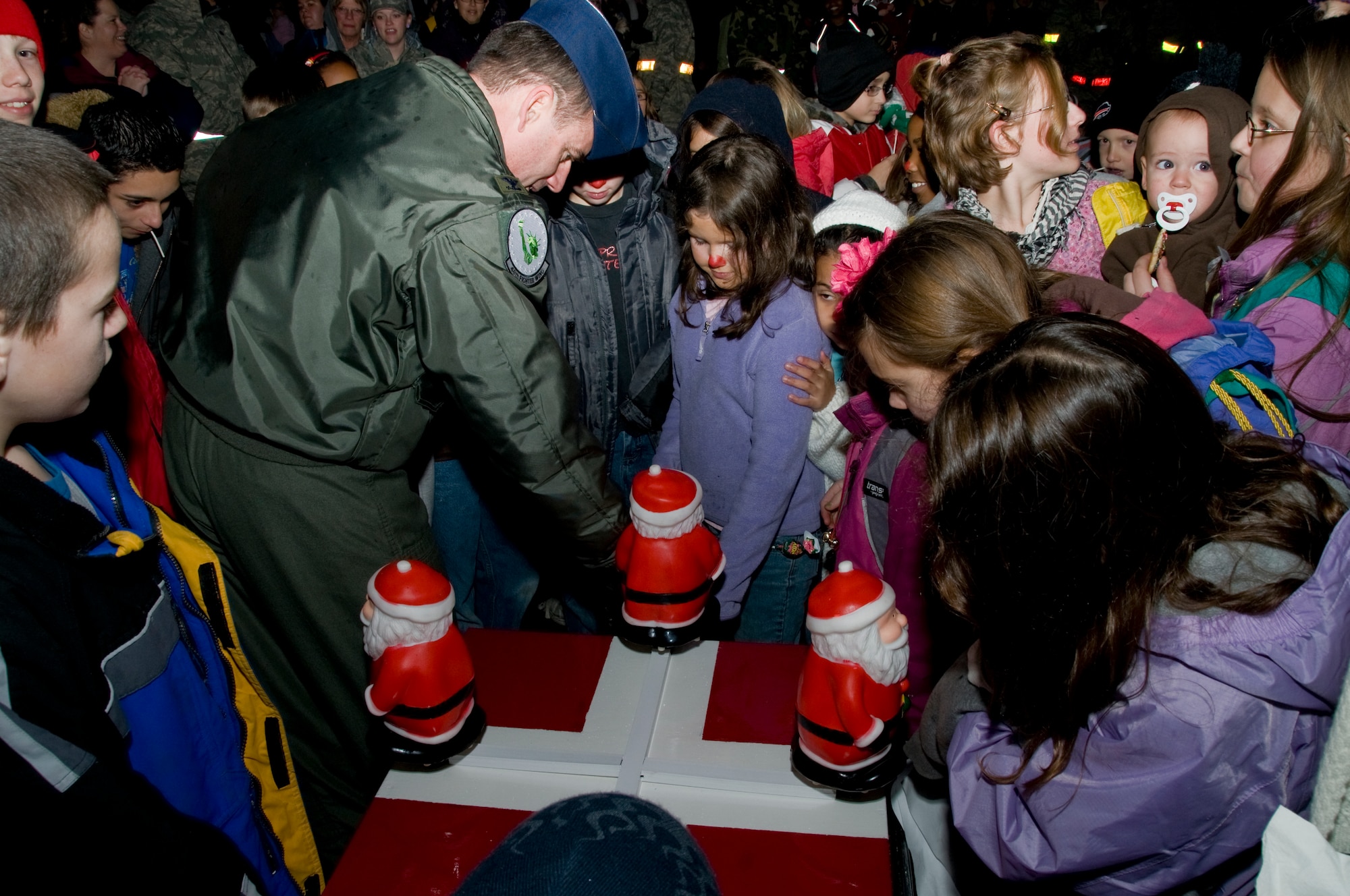Col. Jay Silveria helps the children celebrate the start of the holiday season by turning on the lights on the Christmas tree during the Christmas tree lighting ceremony Dec. 5 at RAF Lakenheath, England. (U.S. Air Force photo by Airman 1st Class Perry Aston) 
