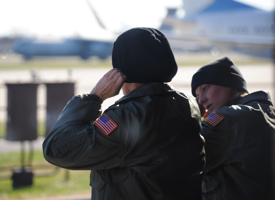 Safety comes first as 932nd Aeromedical Evacuation Squadron members put in ear plugs before heading out to board a plane one cold morning at the 932nd Airlift Wing, Scott Air Force Base.  (U.S. Air Force photo/Maj. Stan Paregien)
