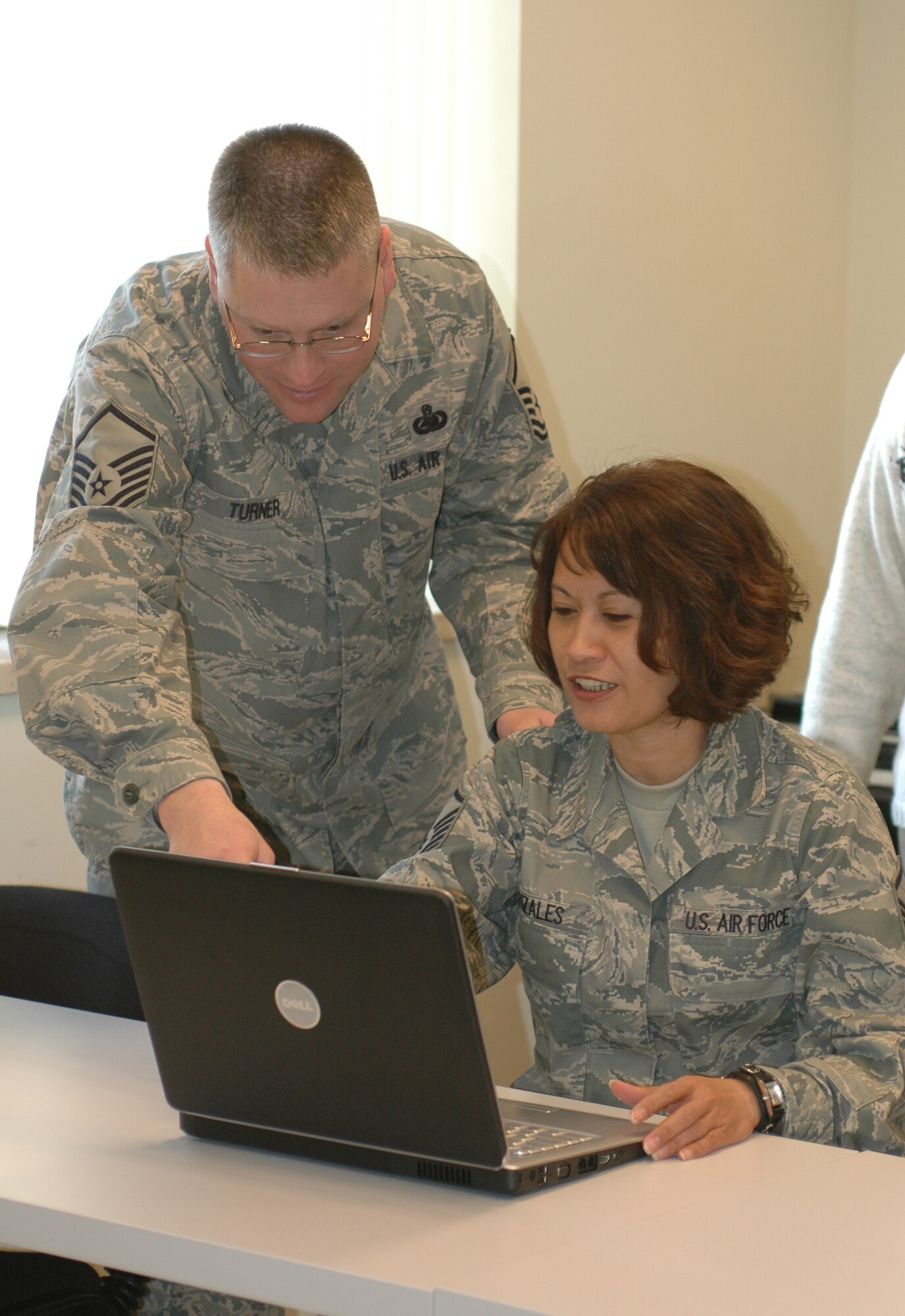 Master Sgts. Mical Turner and Lourene Gonzales of the 31st Force Support Squadron check out one of 12 new laptop computers donated to the Aviano Airman and Family Readiness Center by the Veterans of Foreign Wars Dec. 9. (U.S. Air Force photo/Staff Sgt. Lindsey Maurice)