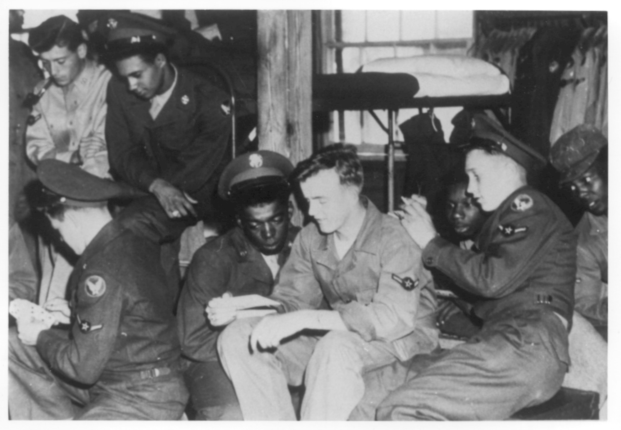 a vintage photo of airmen reading mail