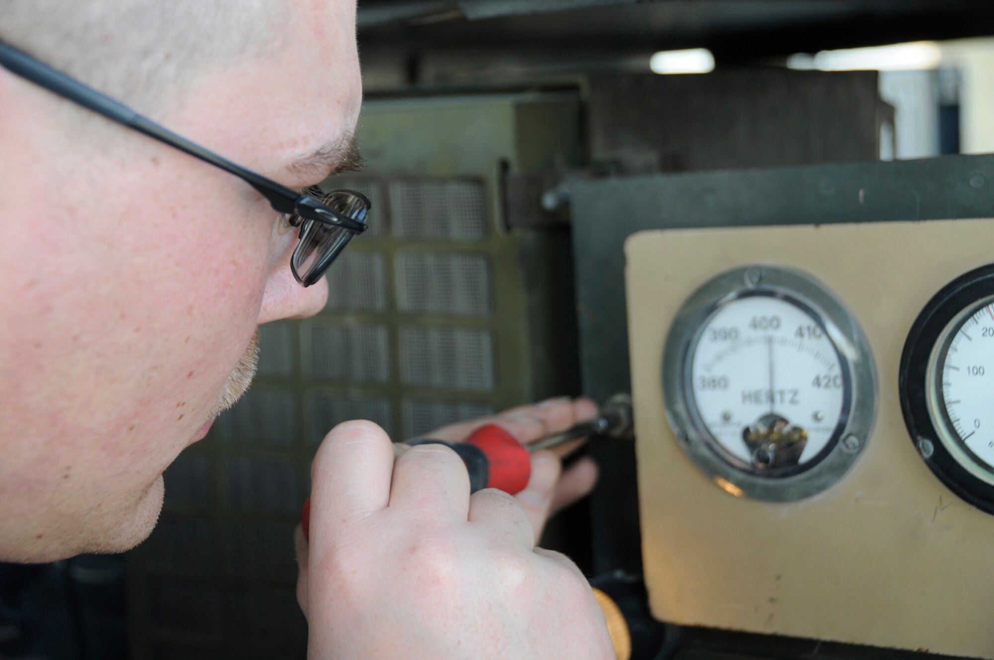 Staff Sgt. Britt Jones, aerospace ground equipment mechanic assigned to the 379th Expeditionary Maintenance Squadron, adjusts the hertz output of an A/M 32A-86 generator using a screwdriver at an undisclosed air base in Southwest Asia Nov. 24, 2008. Sergeant Jones, a native of Brookville, Ind., is deployed from Grand Forks Air Force Base, N.D. (U.S. Air Force photo by Staff Sgt. Darnell T. Cannady) 