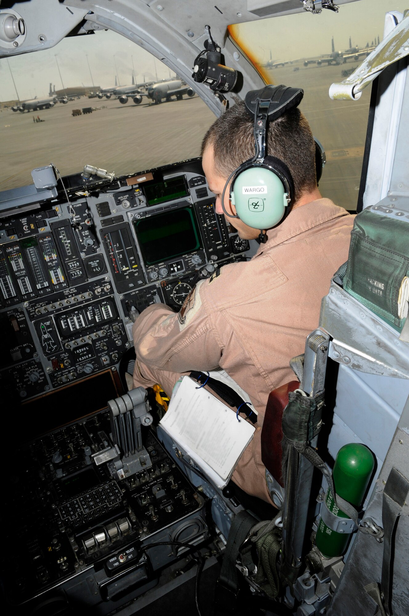 Capt. Aaron Wargo, pilot assigned to the 379th Expeditionary Bomb Squadron, works his way through pre-flight checklists from the copilot seat in the cockpit of a B-1 at an undisclosed base in Southwest Asia, Dec. 9, 2008. A pre-flight crew prepares the aircraft for flight in order to allow the crew actually flying to maximize their available flight time. Captain Wargo hails from Garden Grove, Calif., and is deployed from Ellsworth Air Force Base, S.D.  (U.S. Air Force illustration  by Tech. Sgt. Michael Boquette)