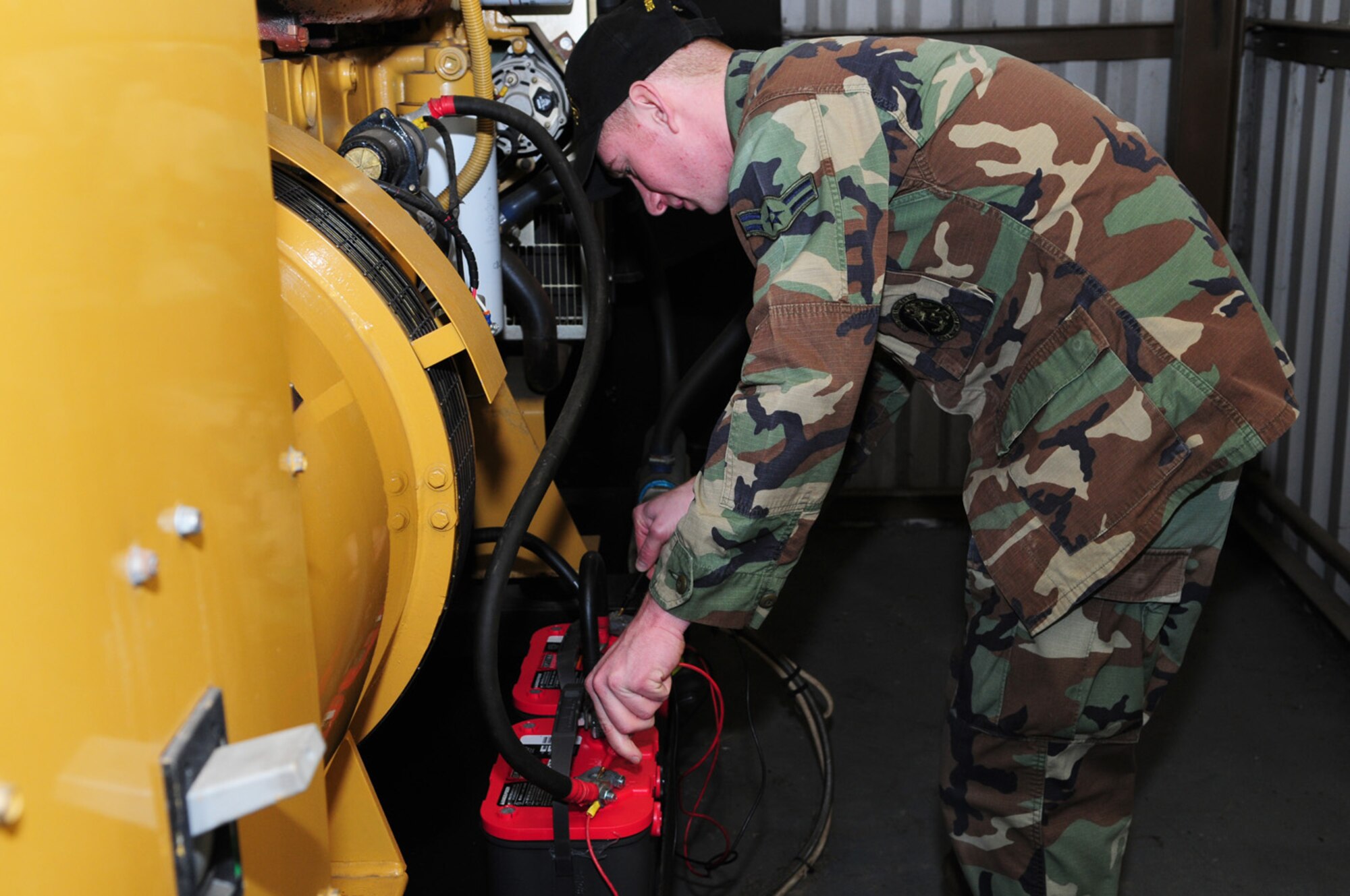 Airman 1st Class Brandon Abrahamson, 100th Civil Engineer Squadron Power Production, checks the battery of a generator using a multimeter. Monthly checks a performed on 28 real property generators around base, which are attached to buildings. Power production technicians are also responsible for maintaining 20 mobile generators. The generators are run for one hour each month under load bank (artificial load) and a yearly inspection is performed, when the oil and filters are changed and an electrical inspection is done. (U.S. Air Force photo by Karen Abeyasekere)