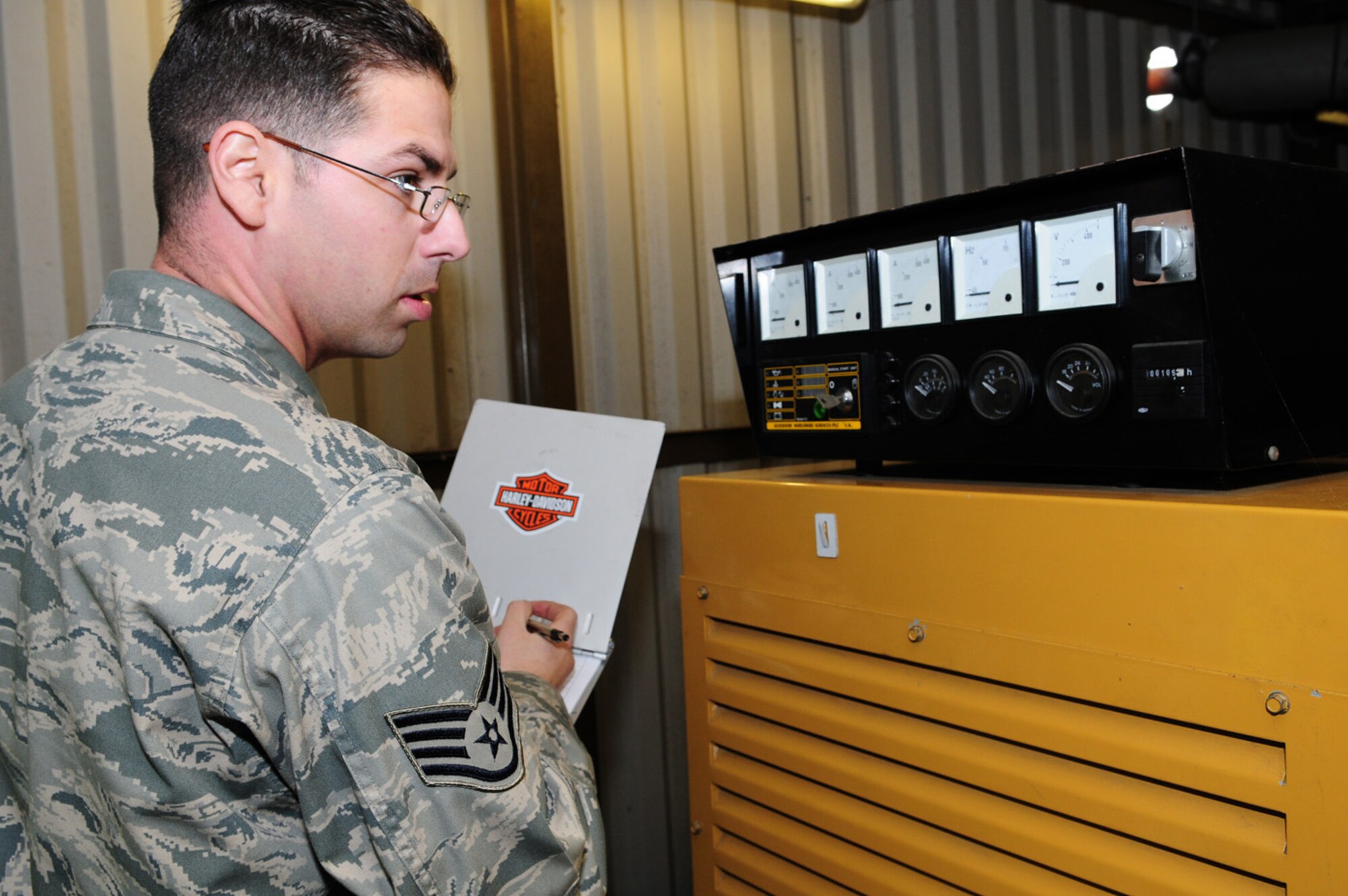 Staff Sgt. Vincent Rizzo, 100th Civil Engineer Squadron Power Production, checks the dials on a generator and records the information on a checklist during the monthly check of a generator.  Power production technicians are also responsible for maintaining 20 mobile generators. The generators are run for one hour each month under load bank (artificial load) and a yearly inspection is performed, when the oil and filters are changed and an electrical inspection is done. Technicians from barrier maintenance and power production work closely together; the only difference is that barrier maintenance personnel work on aircraft arresting systems and the power production staff works on generators. (U.S. Air Force photo by Karen Abeyasekere)