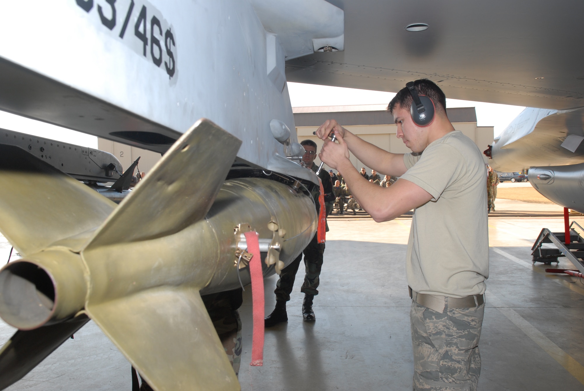 KUNSAN AIR BASE, Republic of Korea --  Airman 1st Class Angel Dearce, 8th Aircraft Maintenance Squadron, 35th Aircraft Maintenance Unit, tightens up  a weapon to an F-16 during a weapons load crew competition here Dec. 12. The best load crews from the  35th and 80th AMUs compete in the weapon load crew competition every month. US Air Force Photo By: Senior Airman Angela Ruiz)