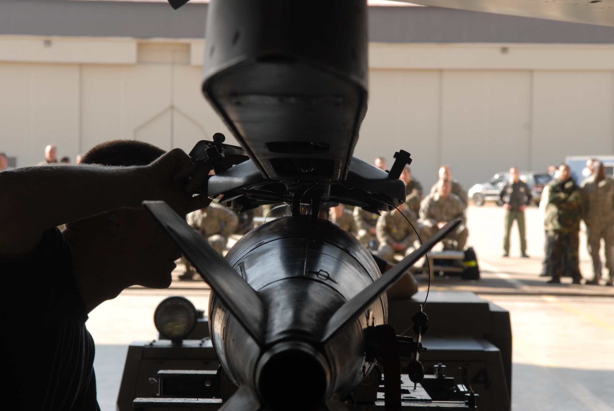 KUNSAN AIR BASE, Republic of Korea -- Staff Sgt. Jason Biddlecome 8th Aircraft Maintenance Squadron, 35th Aircraft Maintenance Unit, lines up the weapon with an F-16 during a weapons load crew competition here Dec. 12. The best load crews from the  35th and 80th AMUs compete in the weapon load crew competition every month. US Air Force Photo By: Senior Airman Angela Ruiz)