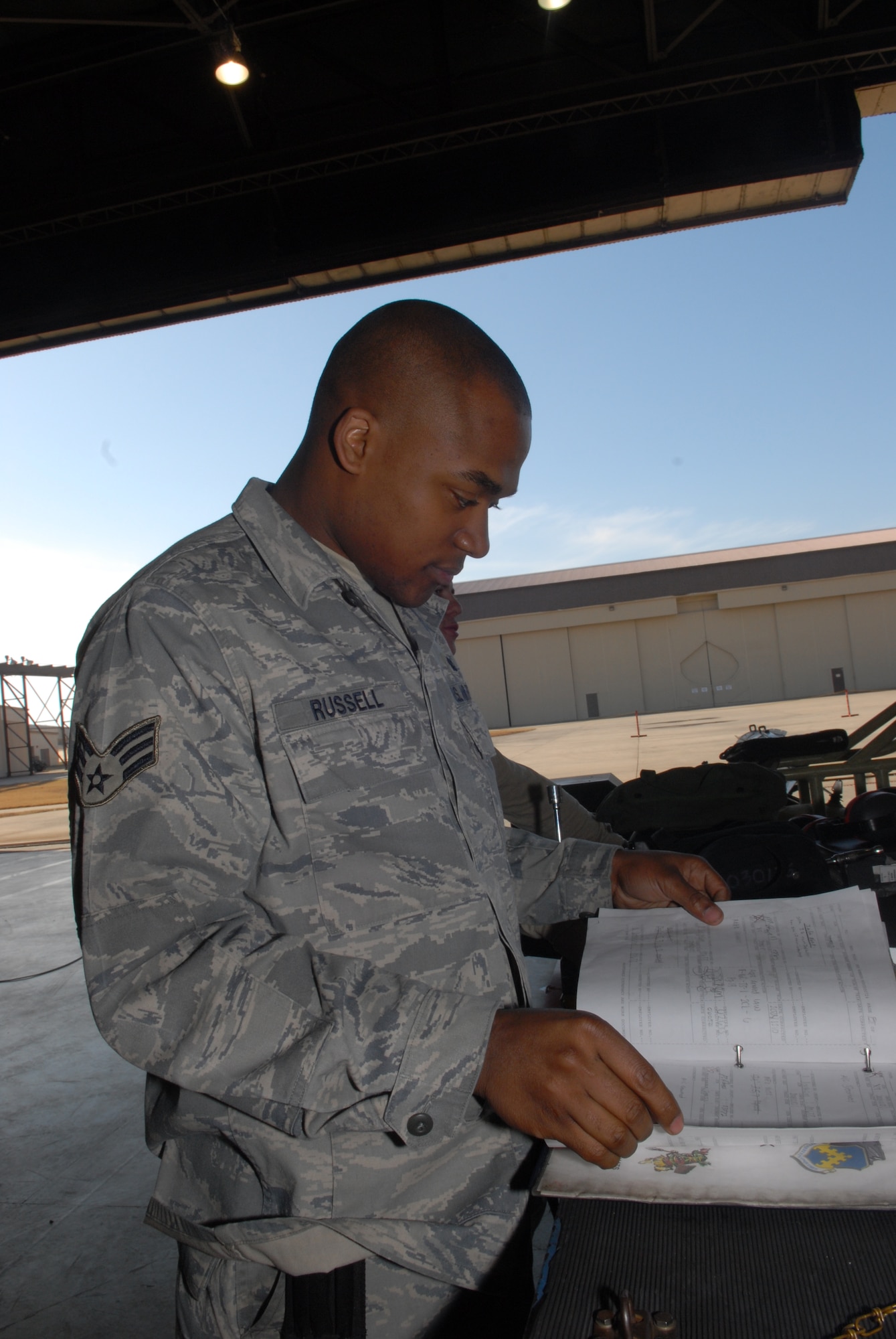 KUNSAN AIR BASE, Republic of Korea --Senior Airman Demetrick Russell, 8th Aircraft Maintenance Squadron, 80th Aircraft Maintenance Unit, reads though a checklist prior to participating in a weapons load crew competition here Dec. 12.  The best load crews from the  35th and 80th AMUs compete in the weapon load crew competition every month. US Air Force Photo By: Senior Airman Angela Ruiz)