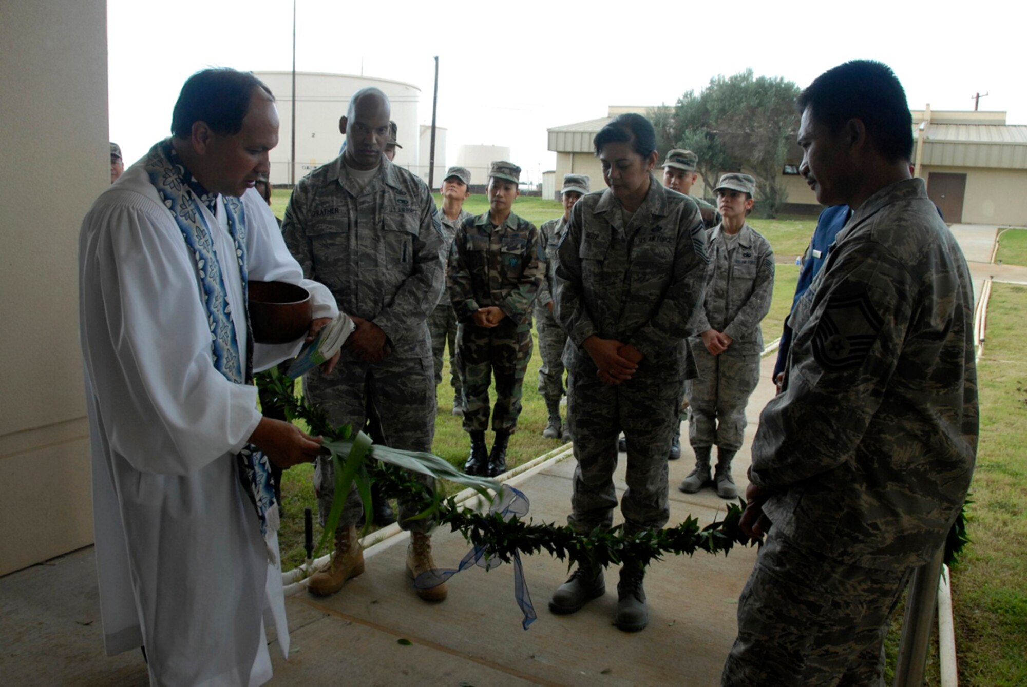 Kahu Kordell Kedoa, a pastor from Kamehameha Schools in Honolulu, blesses a maile lei as part of a Hawaiian blessing ceremony commemorating the opening of a new building for the 624th Regional Support Group December 7, 2008 at Hickam Air Force Base, Hawaii.  The building represents the first structure build specifically for the 624th RSG on the base.  (U.S. Air Force photo by Staff Sgt. Jennie Chamberlin)  
