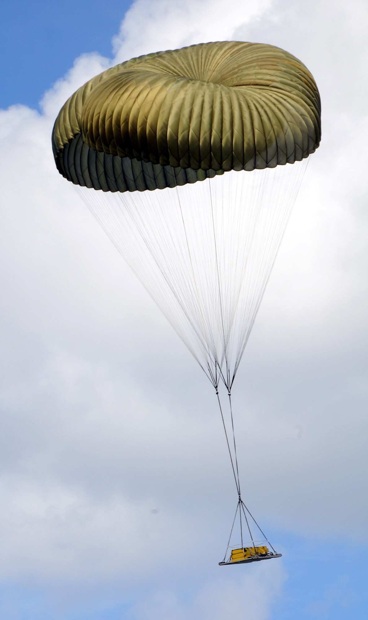 ANDERSEN AIR FORCE BASE, Guam -A pallet glides to the drop zone here Dec. 12, as a practice run was made by two C-130 Hercules in preparation for Operation Christmas Drop. Operation Christmas Drop is a non-profit organization powered by volunteers from Andersen AFB and the local Guam community. Each year, the two join forces to aid the people of smaller islands that do not have airstrips or major ports. (U.S. Air Force photo by Airman 1st Class Courtney Witt) 
