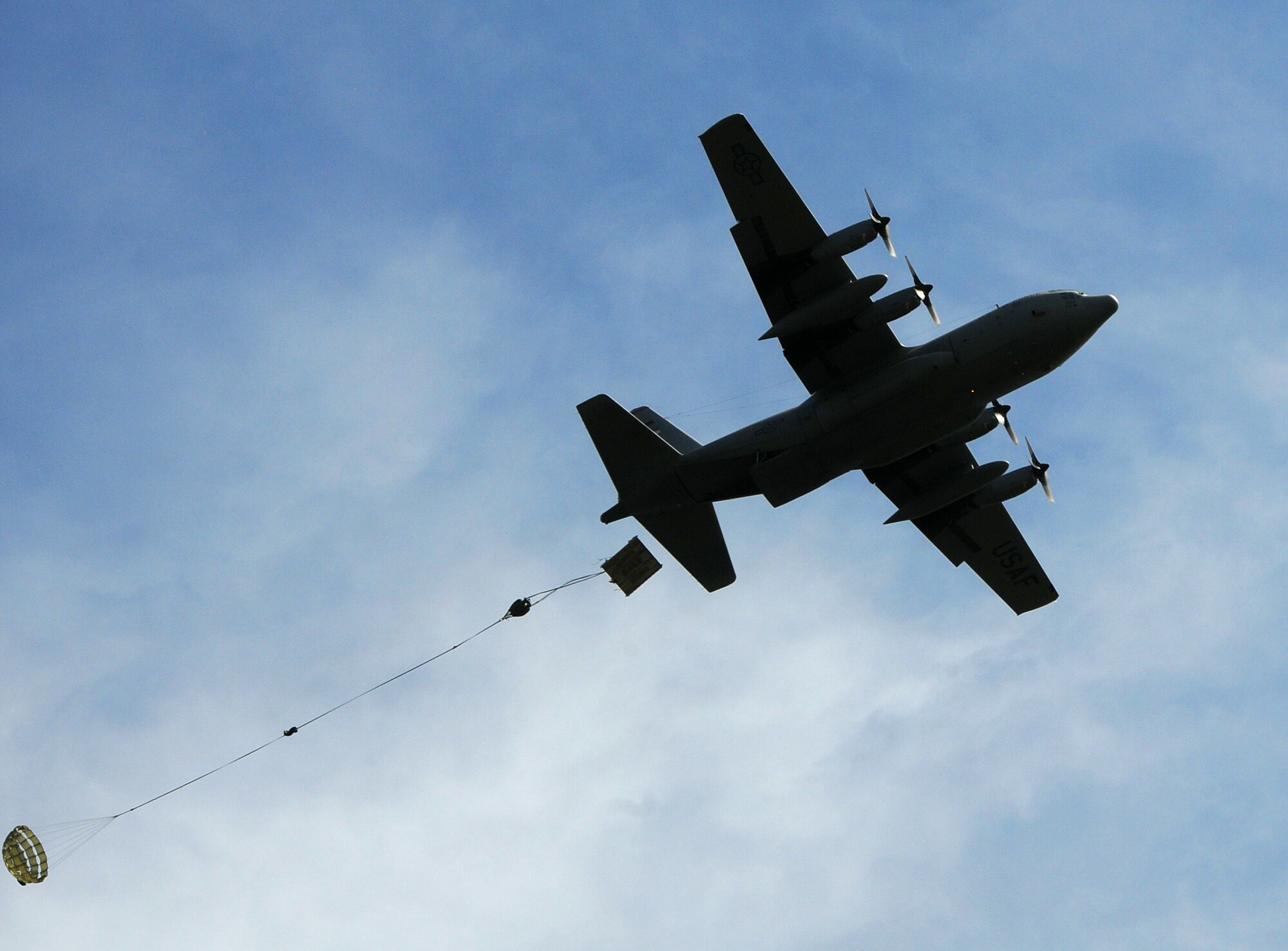 ANDERSEN AIR FORCE BASE, Guam - A C-130 Hercules from Yokota Air Base, Japan, practice an airdrop here Dec. 12 in preparation for Operation Christmas Drop. Through military and local community support, the OCD organization collected nearly 20,000 donated items and raised more than $30,000 through donations and fundraising efforts since the 2008 campaign began in August. (U.S. Air Force photo by Airman 1st Class Courtney Witt)