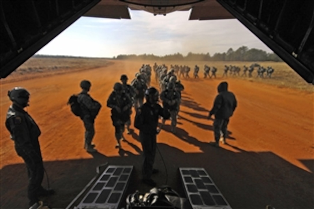 U.S. Army paratroopers board a C-130 Hercules airplane from which they will parachute during Operation Toy Drop on Fort Bragg, N.C., Dec. 6, 2008. The soldiers are assigned to the 82nd Airborne Division. The jump gives soldiers and airmen a way to help local families in need over the holidays. More than 3,000 servicemembers donated a toy to win a chance to earn foreign jump wings from a German or Irish jumpmaster.