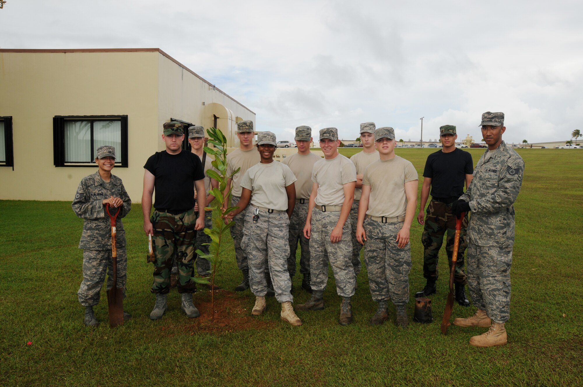 ANDERSEN AIR FORCE BASE, Guam -The First Term Airmen led by instructors, Staff Sgt. Curt Mitchell and Staff Sgt. Yelida Del Valle Ruiz pose for a group photo after planting two trees in font of the First Term Airman Center. (U.S. Air Force photo by Senior Airman Nichelle Griffiths)