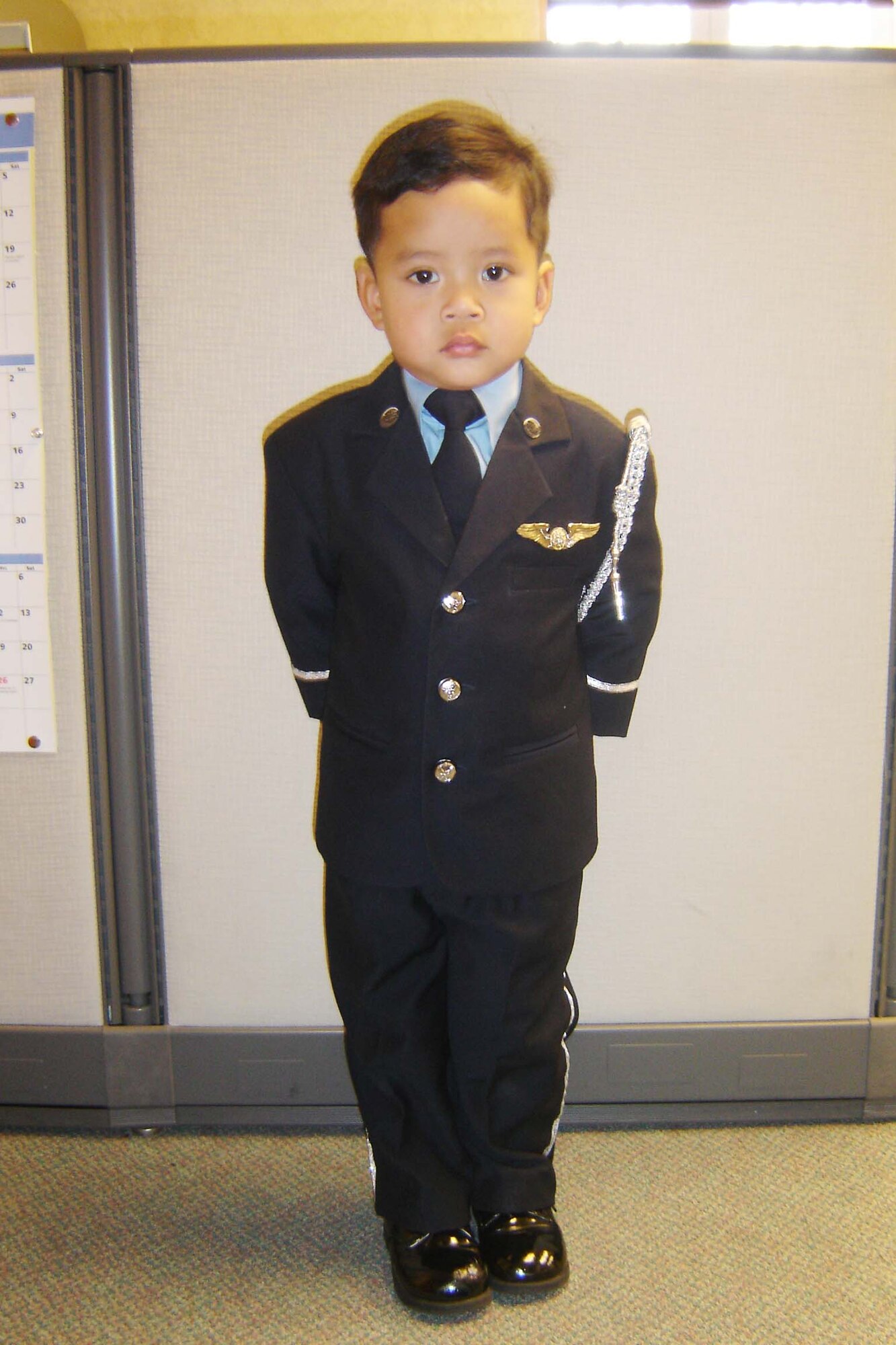 ‘PARADE REST!’  Two-year-old Jacob Vo smartly executes commands given by his uncle, Tech. Sgt. Neil Ballecer, a member of the March Field Honor Guard. Jacob became the Honor Guard’s unofficial mascot this year after Sgt. Ballecer observed him standing at attention and imitating the guard’s movements during official functions. “He’d march around the house at home after the events, or he’d see a military commercial and stand and salute. He even memorized the Star Spangled Banner,” said Sgt. Ballecer. “I didn’t teach him a thing; he did it all himself.” So, the next time Sgt. Ballecer took Jacob to an event - the Annual Honor Guard Banquet in September - he dressed him in a mini “Air Force” Honor Guard uniform. “It was hard to match our Honor Guard uniform, but I bought a little blue suit,” said Sgt. Ballecer. “Then I went to a craft supply store, and I got some piping and sewed it on the wrist of the suit and the side of the pants; I sewed on some old buttons, and I gave him my wings. He’d rather wear that suit than diapers.” (U.S. Air Force photo by Will Alexander)