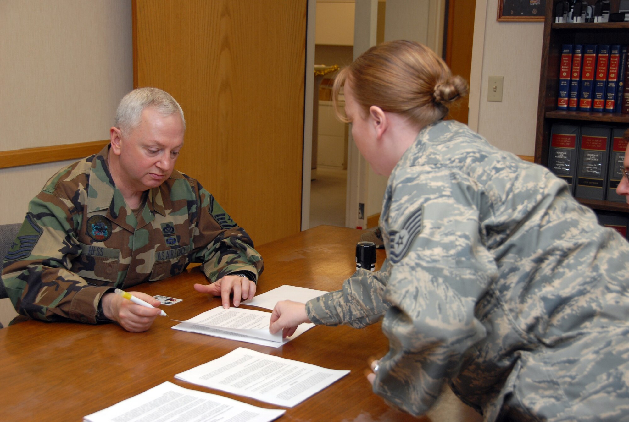 Master Sgt. Cameron Hess, 477th Civil Engineer Squadron, follows specific instructions given by Tech. Sgt. Jennifer Hunt, 3rd Wing legal office, in regards to signing his will. The 477th CES will deploy to Iraq in the spring. This will be the first combat deployment for the squadron since World War II. The 477th CE mission is to plan, build, sustain and protect the base while providing combat-ready, deployable forces. (U.S. Air Force Photo by Staff Sgt. Rhiannon Willard) 

