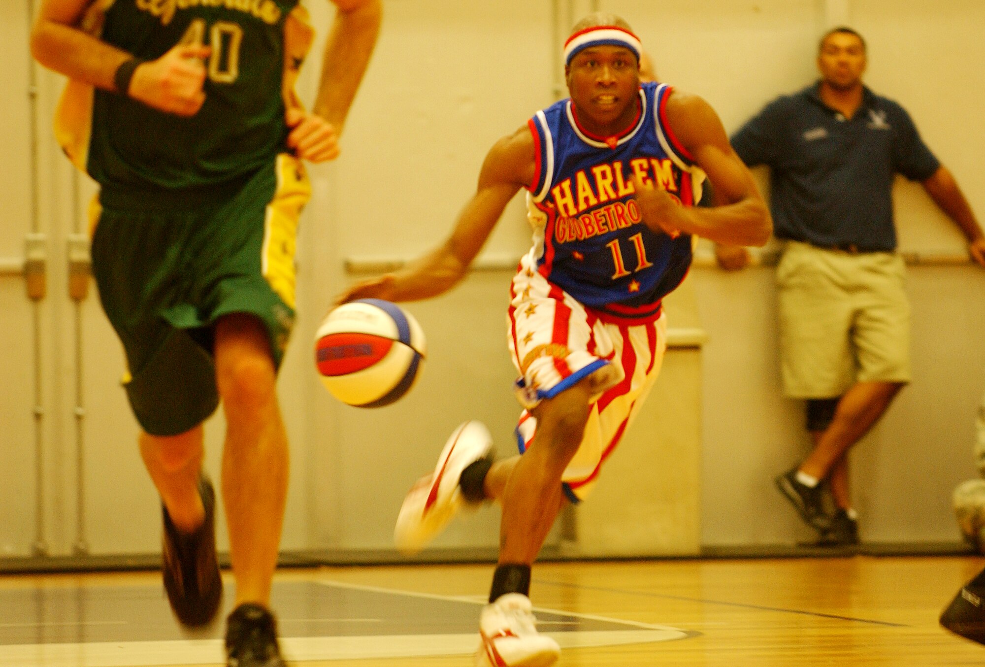 Sweet Pea Shine, a Harlem Globetrotter, dribbles the ball to the hoop Dec. 12 during an exhibition game versus the Washington Generals at the Risner Fitness Center here. While both teams play to win, the Globetrotters mix in their brand of show basketball to entertain the crowd.
(U.S. Air Force official photo/Staff Sgt. Nestor Cruz)