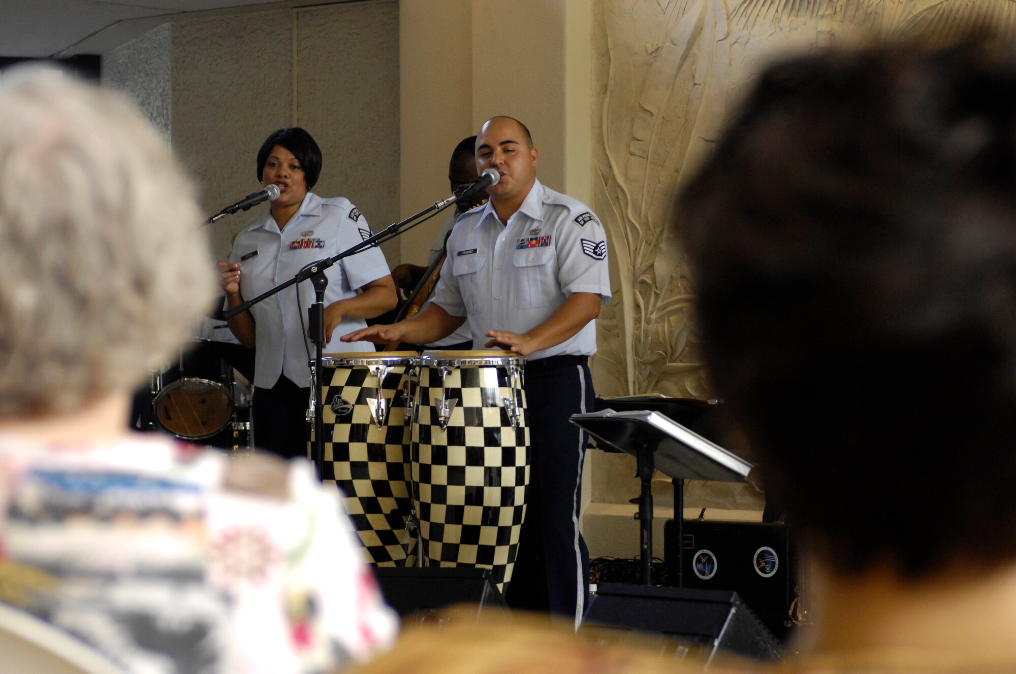 The U. S. Air Force Band of the Pacific-Hawaii members Staff Sgt. Tamiko Boone of Rockingham, N.C. and Staff Sgt. Richard Vasquez of Midland, Texas entertain more than fifty guests of the Hale Koa military resort on Dec. 11, 2008. The band performs at the Hale Koa for at least one show during the holiday season every year. (U.S. Air Force photo by Tech Sgt. Cohen A. Young/Released)