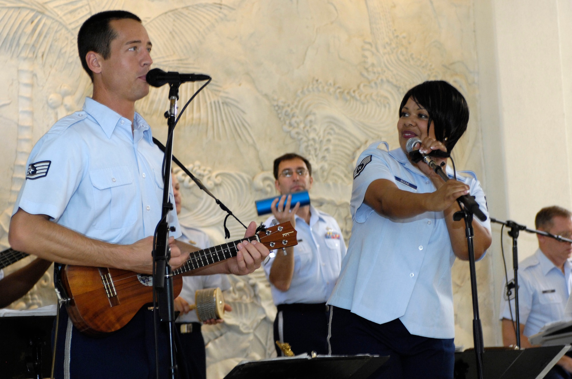 The U. S. Air Force Band of the Pacific-Hawaii members Staff Sgt. Johnny Kukan of Uniontown, Pa. and Staff Sgt. Tamiko Boone of Rockingham, N. C. entertain more than fifty guests of the Hale Koa military resort on Dec. 11, 2008. The band performs at the Hale Koa for at least one show during the holiday season every year. (U.S. Air Force photo by Tech Sgt. Cohen A. Young/Released)