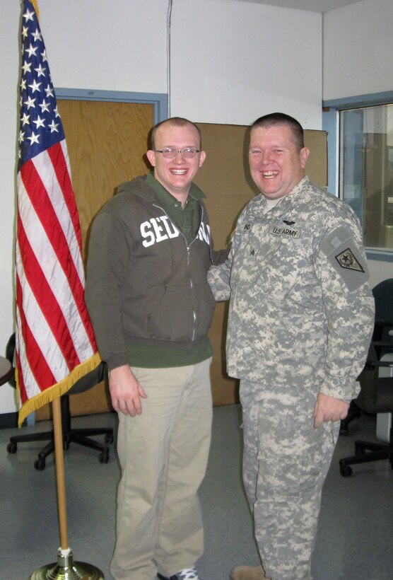 Amn Bond (left) celebrates his enlistment into the U.S. Air Force Reserve with his father, Army National Guard Sgt. Curtis Bond, during a swearing-in ceremony at Nellis Air Force Base, Nev., Dec. 12. Airman Bond, 926th Group's first non-prior military service recruit, is assigned to the 78th Reconnaissance Squadron.