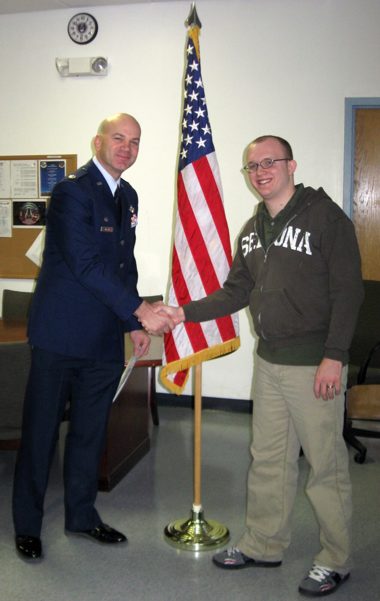 Amn Bond (right) shakes hands with Lt. Col. Stefanik after being sworn into the U.S. Air Force Reserve at a ceremony at Nellis Air Force Base, Nev., Dec. 12. Airman Bond is the 926th Group's first non-prior military service recruit.