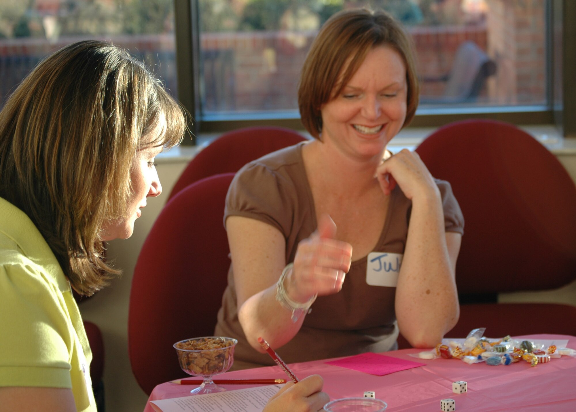 Crystal Ross (left) and Julie Flolo (center) play a game of Bunko during a Key Family Member Program fun night in June 2008. Both Mrs. Ross and Mrs. Flolo are family members of 302nd Airlift Wing reservists. (U.S. Air Force photo/Ann Skarban)