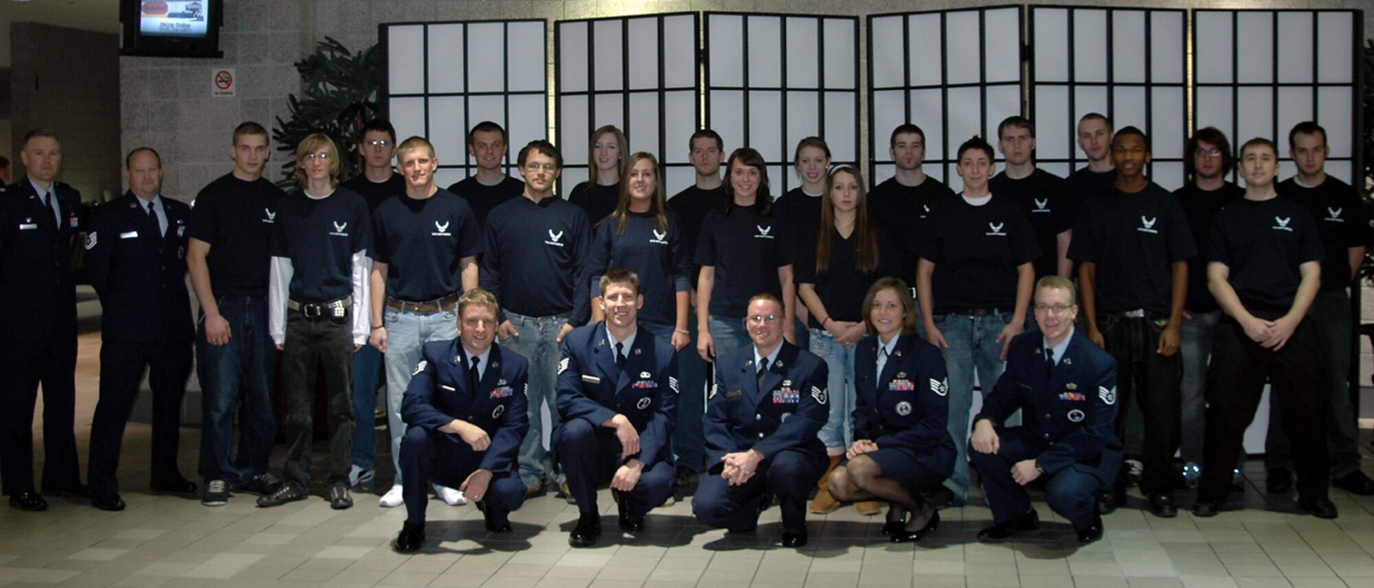 Members of the 347th Recruiting Squadron pause for a photo after conducting a public swearing-in ceremony for 20 Delayed Entry Program members Dec. 12 in the Milwaukee, Wisc., Bradley Center. The event was made possible by a partnership between the 347th RCS and the American Hockey League’s Milwaukee Admirals. (U.S. Air Force photo/Staff Sgt. Joseph Hansen)