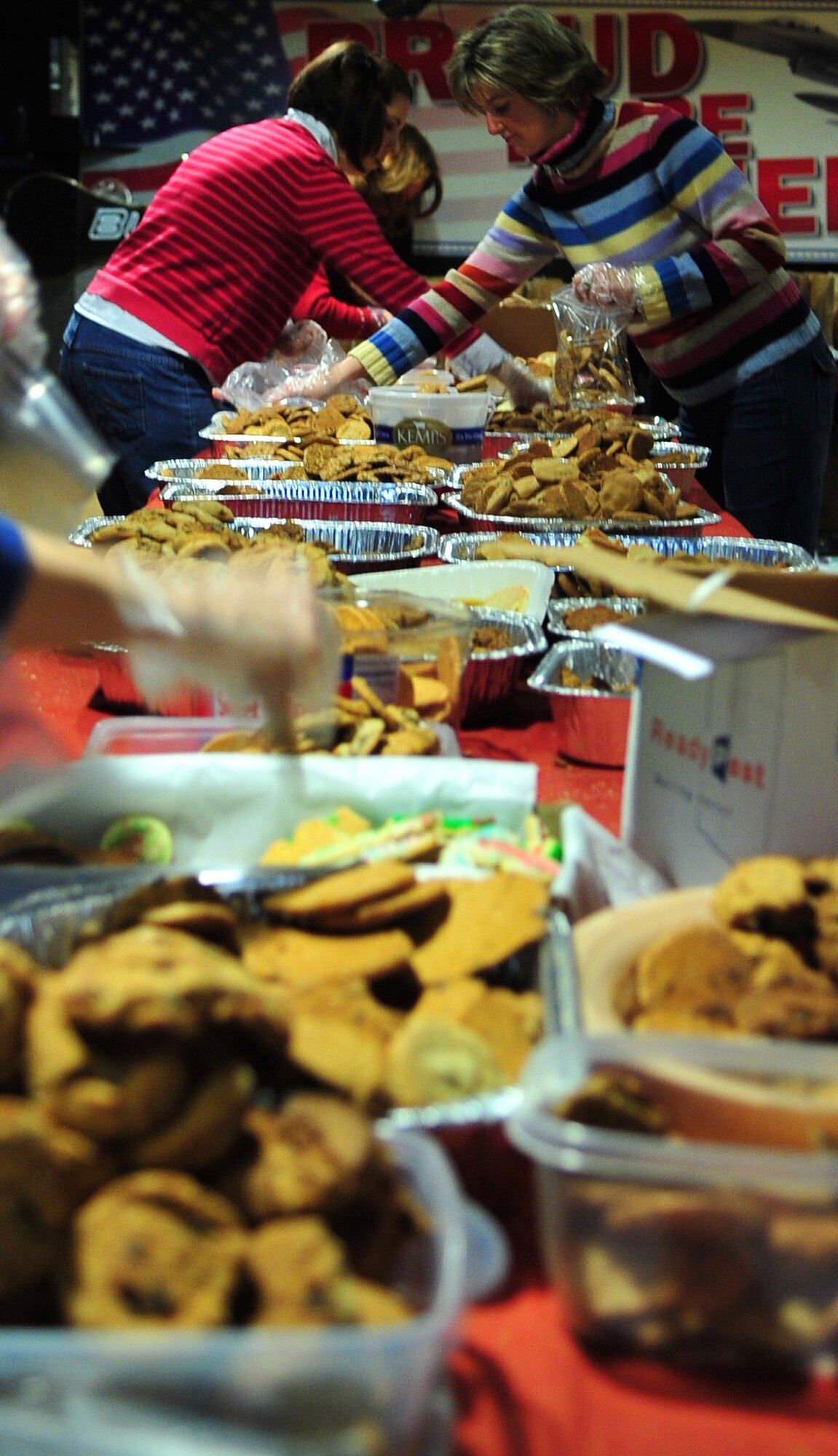 Volunteers with Operation Cookie Crunch package cookies for Airmen living in the dorms this holiday season. More than 14,500 homemade cookies were donated this year, bringing a taste of home to those away from their families. (U.S. Air Force photo/Airman 1st Class Willard E. Grande II)