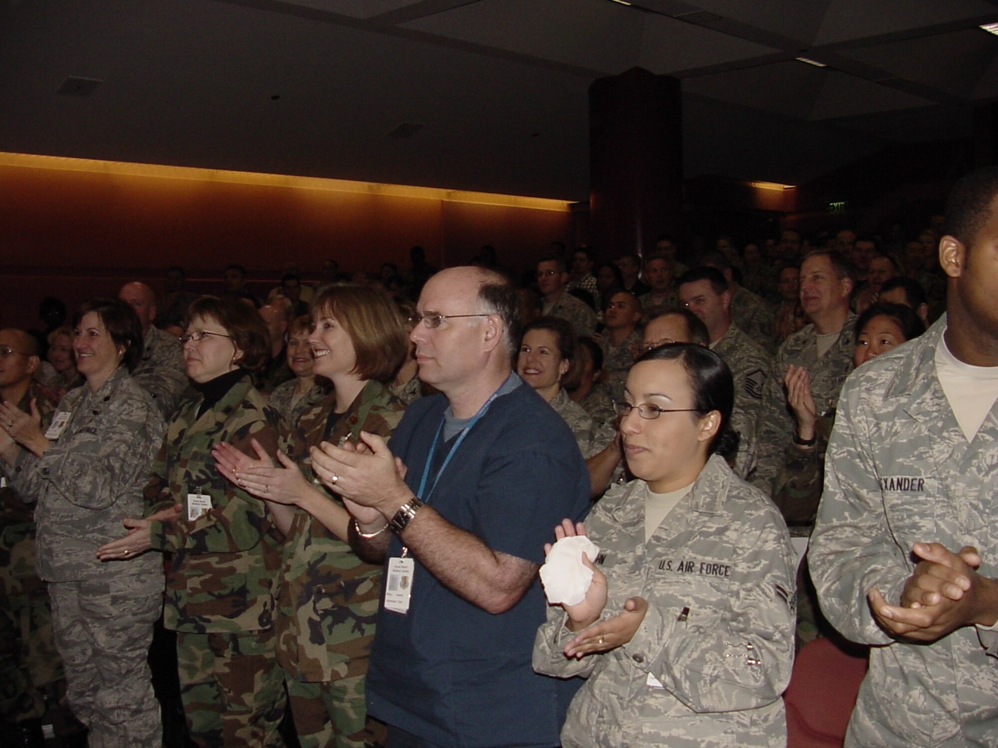 A crowd of DGMC medics give a standing ovation upon news the 60th Medical Group received an “Excellent” rating by the Air Force Inspection Agency’s Healthcare Services Inspection team held in the David Grant USAF Medical Center auditorium (U.S. Air Force photo/Jim Spellman)