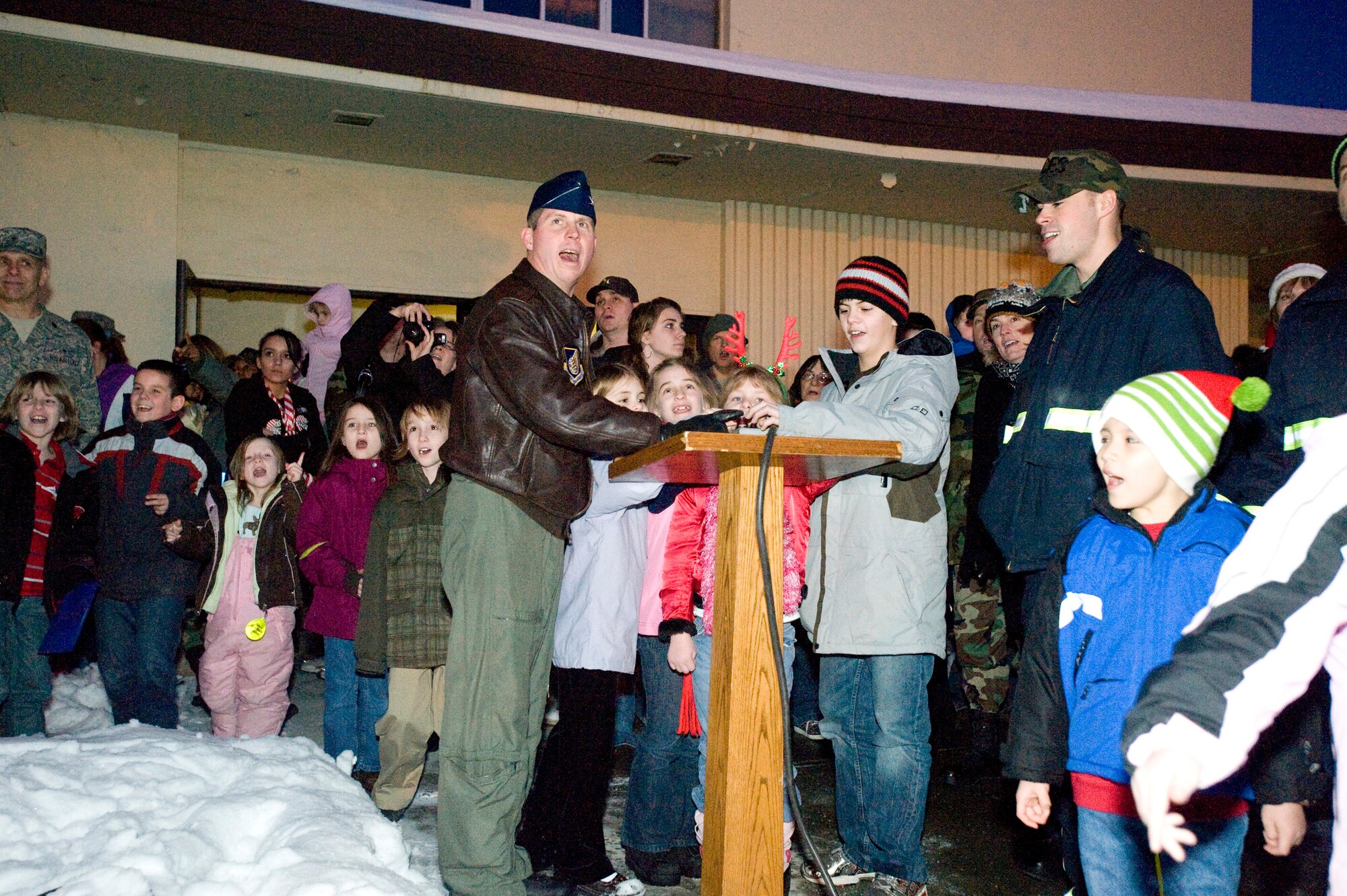 ELMENDORF AIR FORCE BASE, Alaska -- Col. Thomas Bergeson, 3rd Wing commander, hits the switch for the Christmas tree lighting at Chapel 1 Dec.  11. Nearly 200 people went to this year's annual event. (U.S. Air Force photo/Senior Airman Jonathan Steffen)