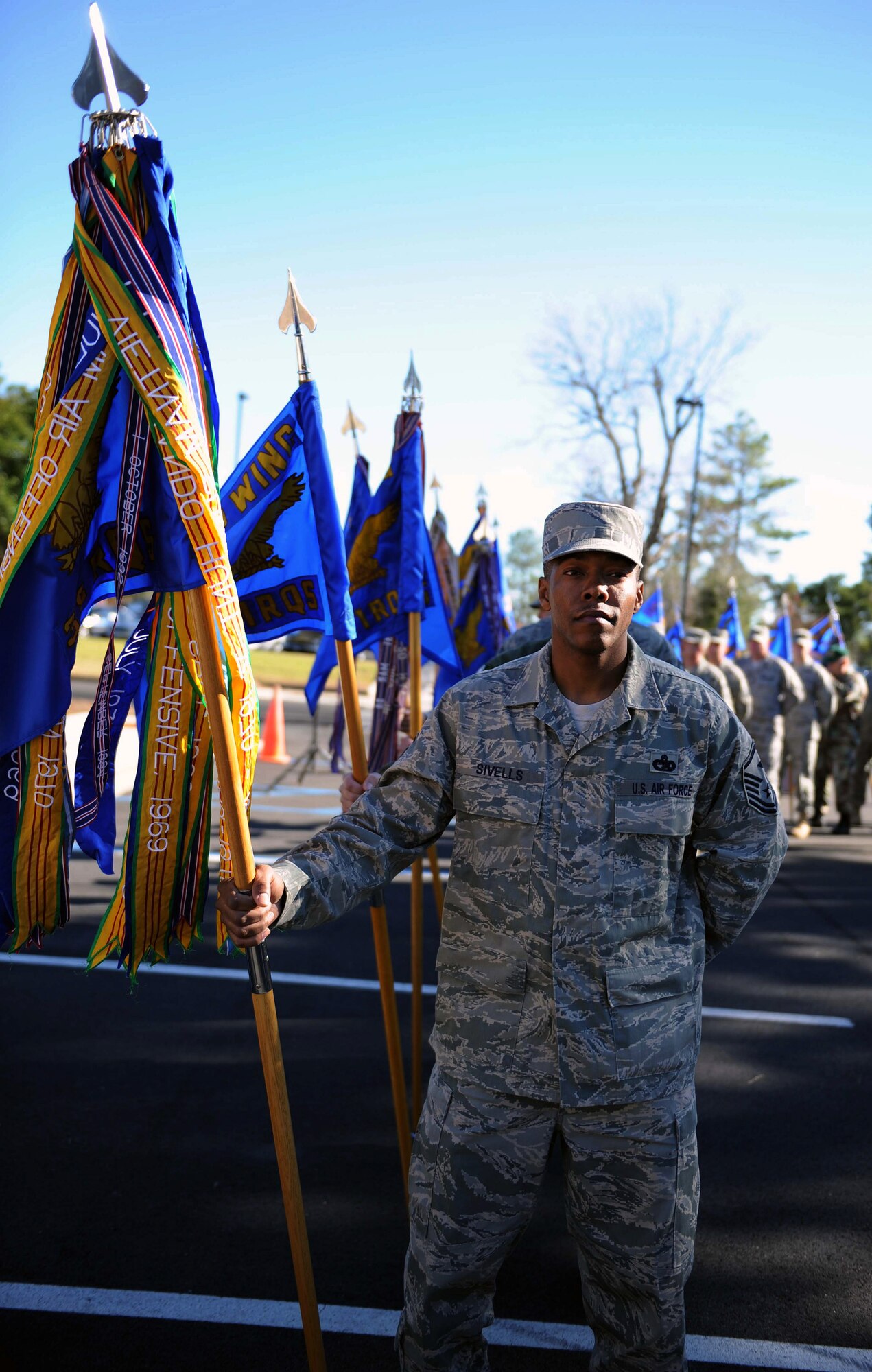 MOODY AIR FORCE BASE, Ga. --- Master Sgt. Glenn Sivells, 38th Rescue Squadron first sergeant, leads the way for Airmen presenting the guidon to the commanders during the Honorary Commander Change-of-Command ceremony Dec. 12 here. Twenty honorary commanders assumed command during the ceremony. (U.S. Air Force photo by Airman Joshua Green)