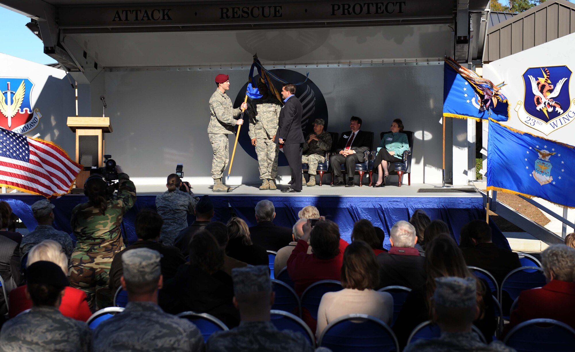 MOODY AIR FORCE BASE, Ga. -- Maj. Mark Scepansky, 38th Rescue Squadron director of operations, passes the guidon to Trey Taylor here during the Honorary Commander Change-of-Command ceremony Dec. 12 signifying his new position as the honorary commander for the 38th RQS.  (U.S. Air Force photo by Airman Joshua Green)