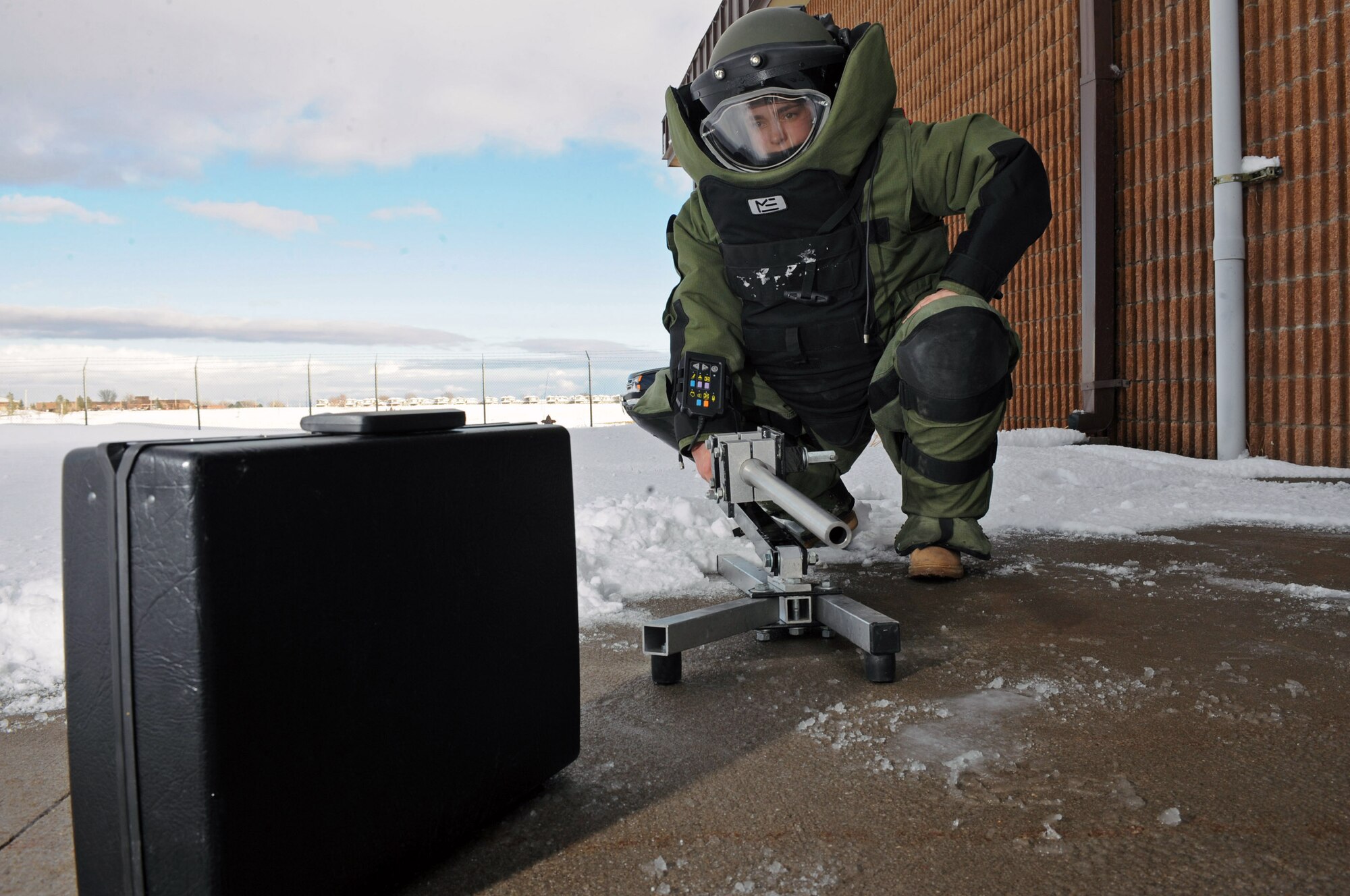 Senior Airman Alicia Goodner, 28th Civil Engineer Squadron Explosive Ordinance Disposal operator, demonstrates using a Percussion Actuated non-electric disrupter here, Dec. 11. PAN disrupters are designed to remotely disrupt explosive devices. (US Air Force photo/Airman 1st Class Corey Hook)