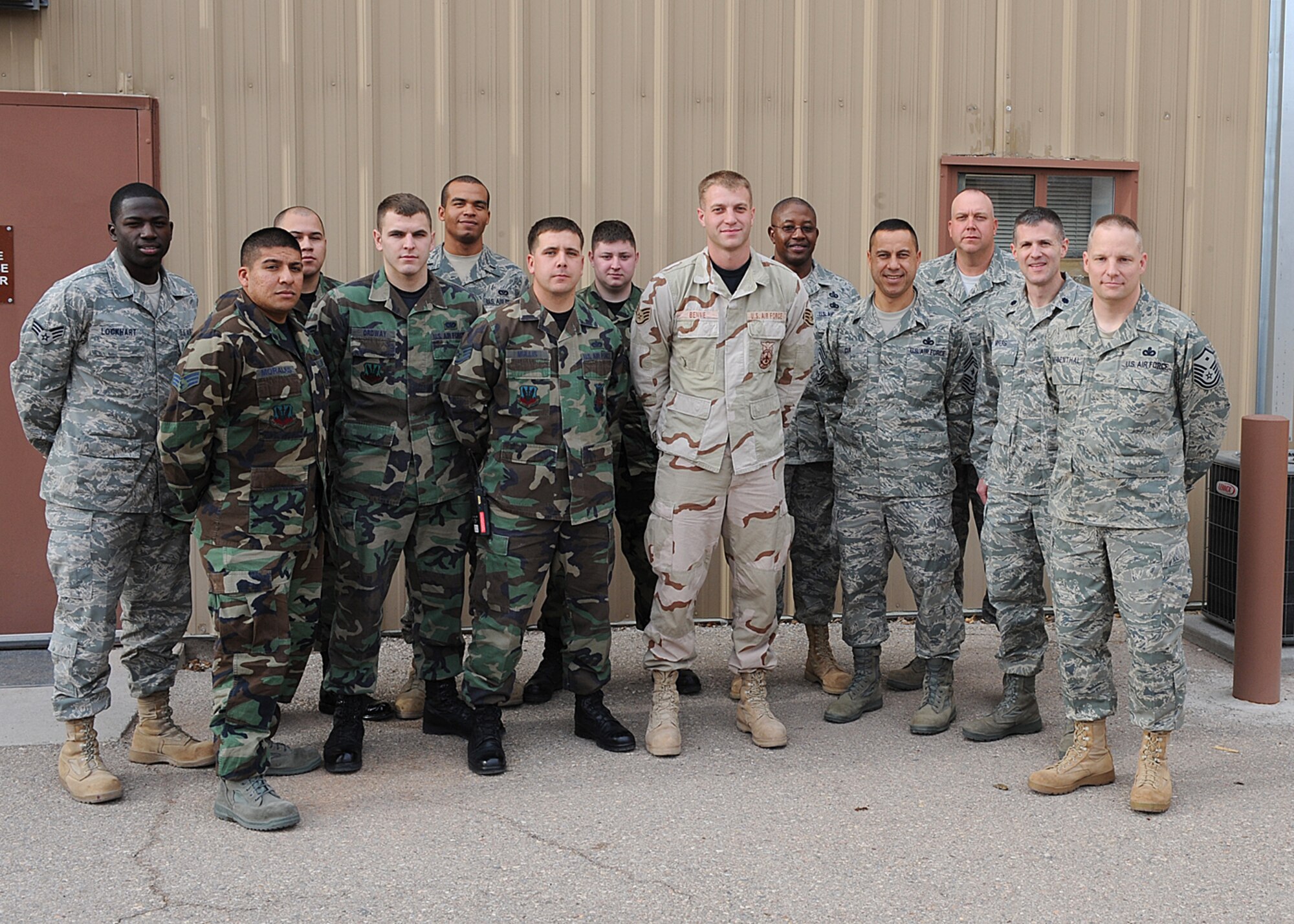 Staff Sgt. Travis Benne, 49th Civil Engineers Squadron, poses for a photo with other members of the 49th CES after returning from his deployment Dec.13, at Holloman Air Force Base, N.M. Sergeant Benne was deployed to Iraq for three months. (U.S. Air Force photo by Airman 1st Class John D. Strong II)