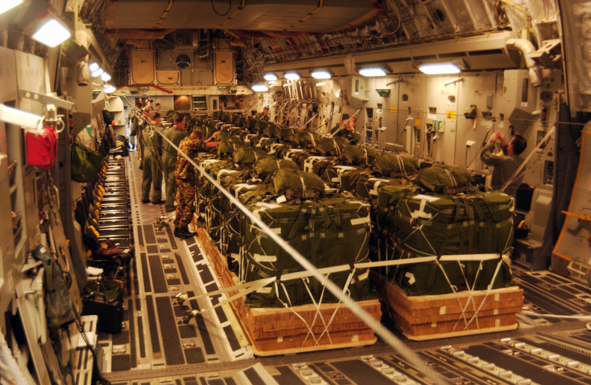 Airmen and members of the New Zealand Defence Force secure supplies and inspect a load prior to a Dec. 1 airdrop mission to the Antarctic Gamburtsev Mountain Province. The Airmen and the C-17 Globemaster III are from McChord Air Force Base, Wash. (U.S. Air Force photo/Staff Sgt. Eric Burks) 
