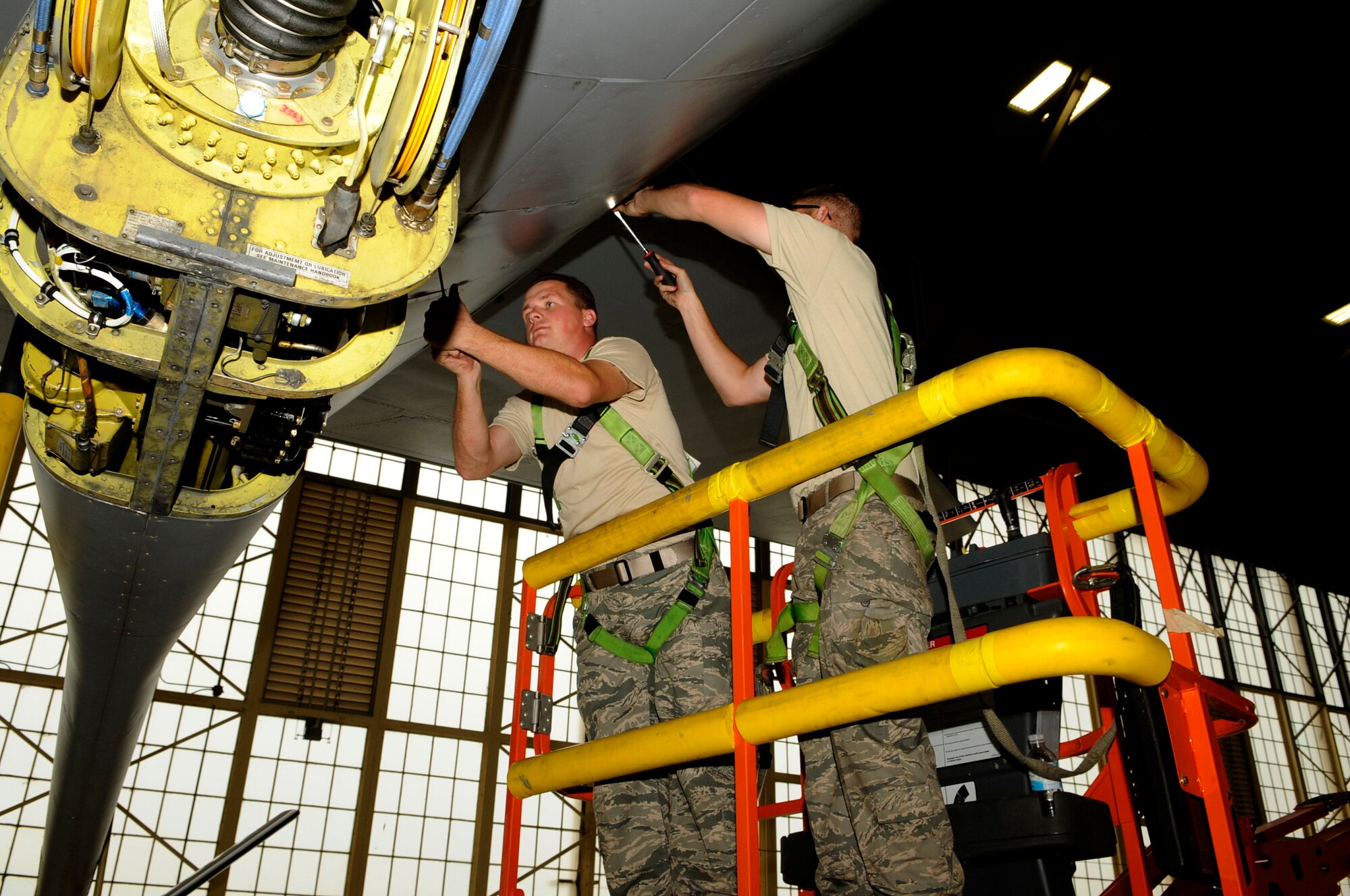 Staff Sgt. Marcus Struck and Senior Airman Nicholas Rogers, 6th Maintenance Squadron Crew Chiefs screw the aircraft panels back into place on tail end of a KC135 aircraft from Andrews AFB, Va. here, Dec. 11 in Hangar two. The KC135 has been here a week for a periodic inspection after being grounded for two months at Andrews due to shortage of personnel. The aircraft was granted a time flight to MacDill in order to have the periodic inspection conducted faster, saving time and using manpower efficiently, all part of the Air Force Smart Operations for the 21st Century strategy. A KC135 receives two periodic inspections every five years. This inspection was completed in five days compared to three weeks with teamwork of 24 Airmen: 16 active duty from MacDill, four Reserve from the 927th Air Refueling Wing and four Airmen from Andrews.
