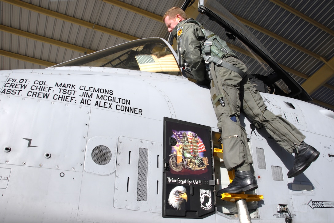 Maj. Les Bradfield, an A-10 pilot in the 442nd Fighter Wing, climbs into an A-10 Thunderbolt II cockpit prior to taking off on a training flight from Whiteman Air Force Base, Mo., Dec. 6, 2008.  The 442nd is an Air Force Reserve Command unit, which operates, maintains and supports a squadron of A-10s.  (U.S. Air Force photo/Staff Sgt. Tom Talbert)