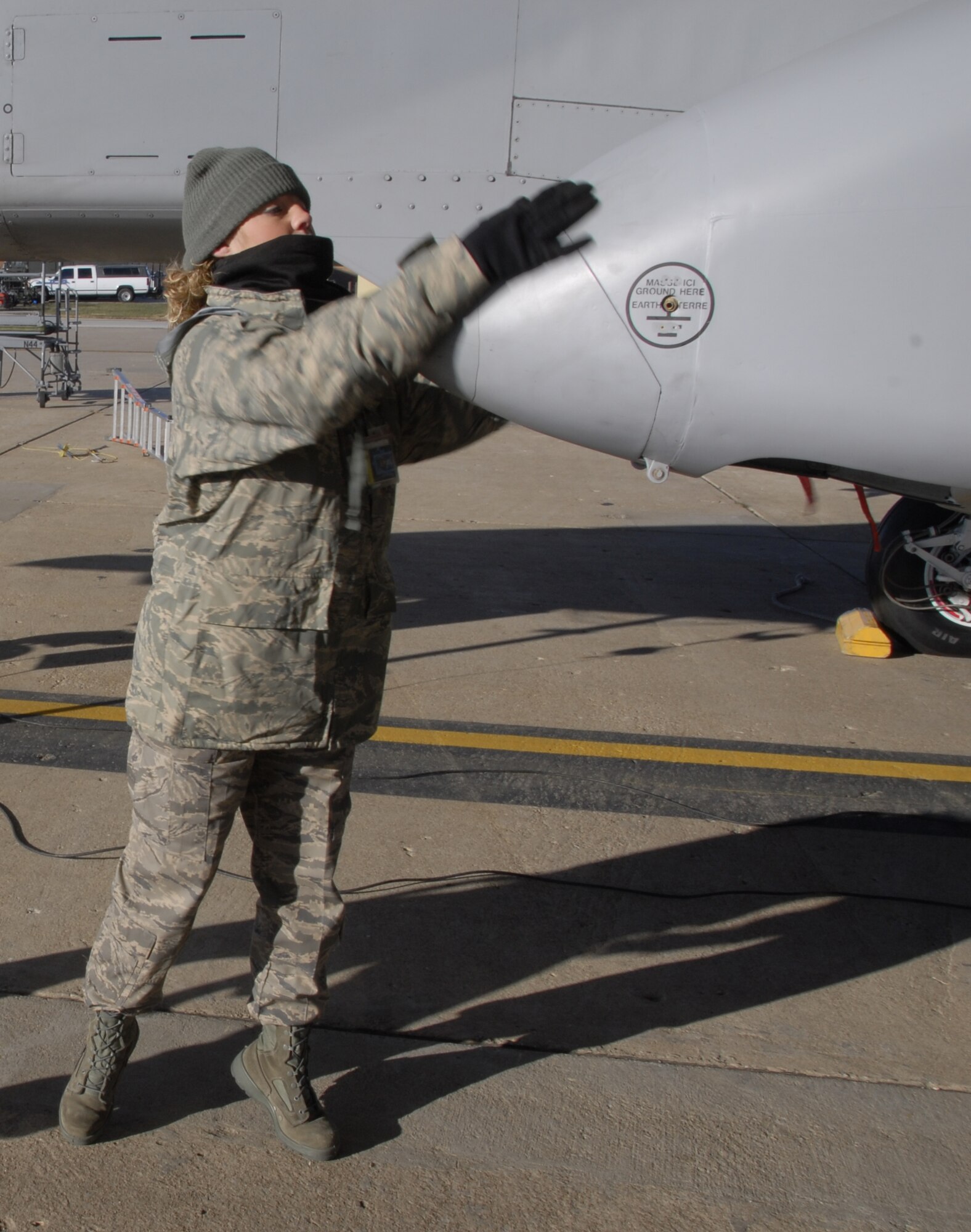 Senior Airman Andrea Sumner closes the cover over the refueling point on a 442nd Fighter Wing A-10 Thunderbolt II at Whiteman Air Force Base, Mo., Dec. 6, 2008, prior to the plane's launch on a training flight.  The 442nd is an Air Force Reserve Command unit, which operates, maintains and supports A-10 combat operations worldwide.  (U.S. Air Force photo/Staff Sgt. Tom Talbert) 