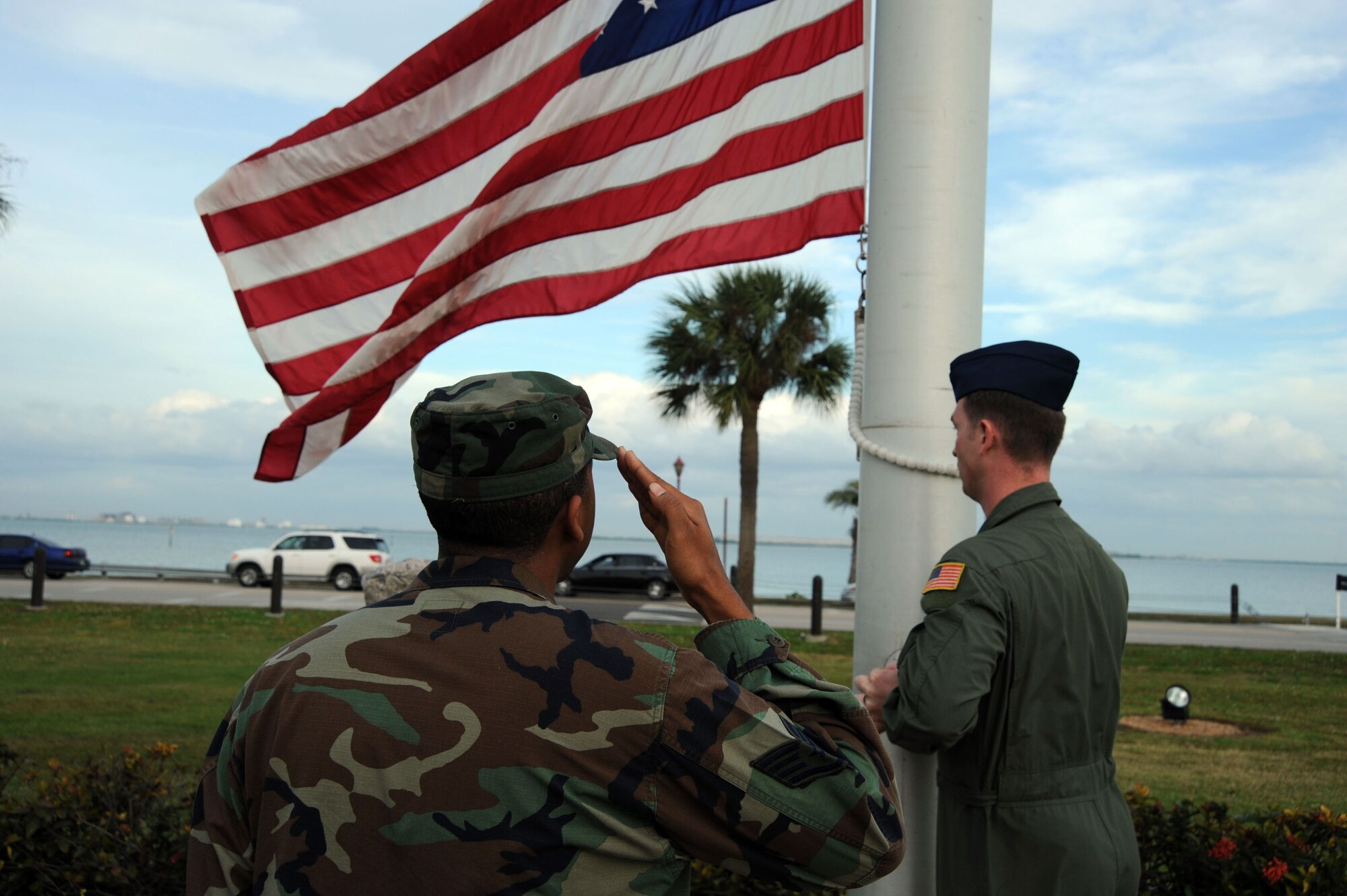 Staff Sergeant Kenneth Belcher, 310th Air Refueling Squadron, "Present, ARMS" during the installation retreat ceremony Dec.10 at MacDill's memorial park. Sgt Belcher the senior member of the detail will remain at attention while the flag is being folded unless needed to control the flag. When the flag is completely folded, only the blue field should be visible and it should be folded in the triangular shape of a cocked hat. The retreat ceremony serves a twofold purpose which is signaling the end of the official duty day and serves as a ceremony for paying respect to the United States flag. MacDill AFB instruction 36-2203 mandates the ceremony will be held every second Wednesday. This instruction applies to all 6th Air mobility wing subordinate units and staff agencies assigned to MacDill. The monthly retreat ceremony is an esprit de corps program to foster teamwork and pride in the 6 AMW and to publicly display our respect for the flag of the United States of America.  (U.S. Air Force photo by Staff Sgt. Ronnie Hill)