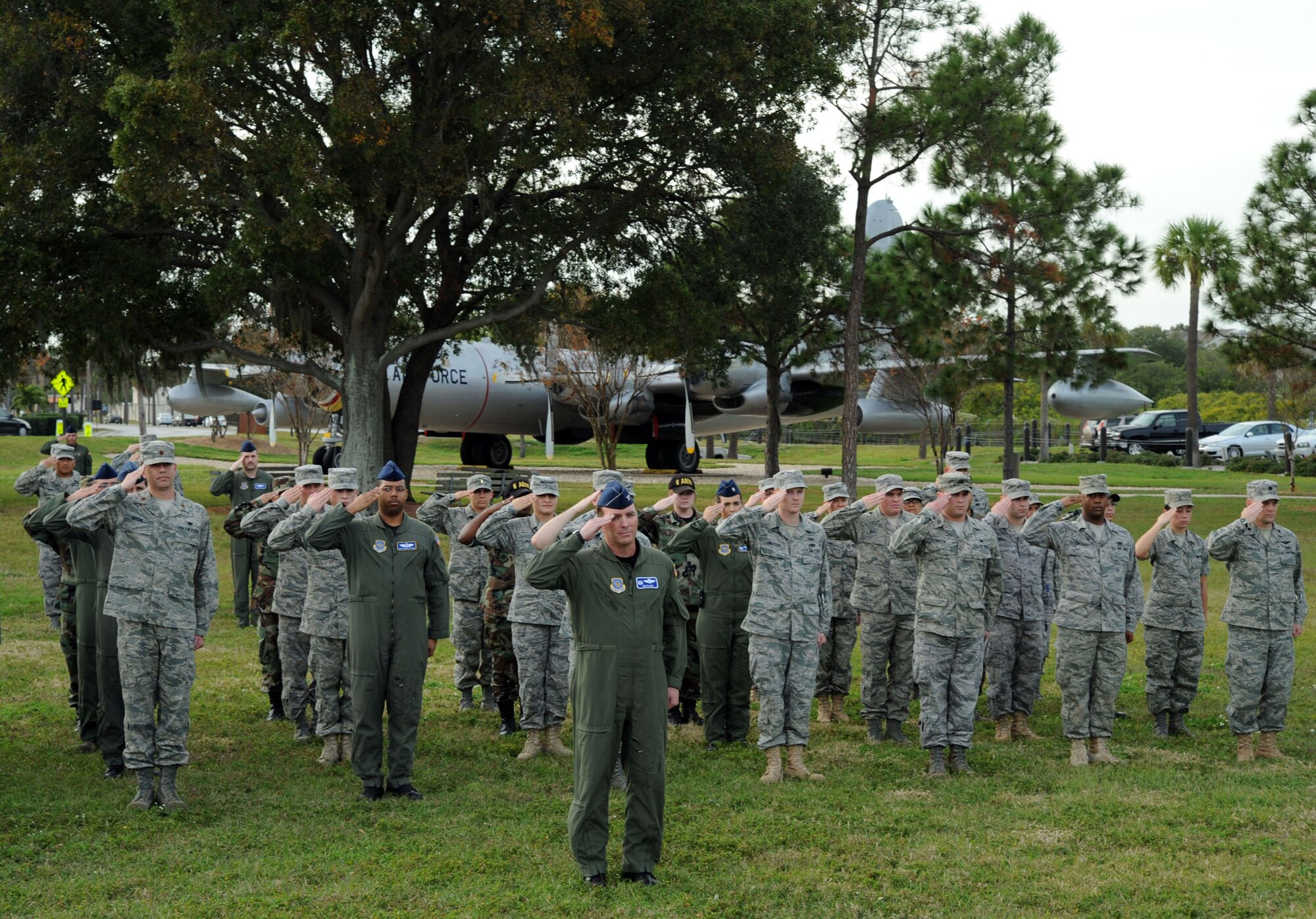 Colonel Jon Klaus, Commander 6th Operations Group, executes "Present, ARMS" during the installation retreat ceremony Dec.10 at MacDill's memorial park. When the flag is completely folded, only the blue field should be visible and it should be folded in the triangular shape of a cocked hat. The retreat ceremony serves a twofold purpose which is signaling the end of the official duty day and serves as a ceremony for paying respect to the United States flag. MacDill AFB instruction 36-2203 mandates the ceremony will be held every second Wednesday. This instruction applies to all 6th Air mobility wing subordinate units and staff agencies assigned to MacDill. The monthly retreat ceremony is an esprit de corps program to foster teamwork and pride in the 6 AMW and to publicly display our respect for the flag of the United States of America.  (U.S. Air Force photo by Staff Sgt. Ronnie Hill)