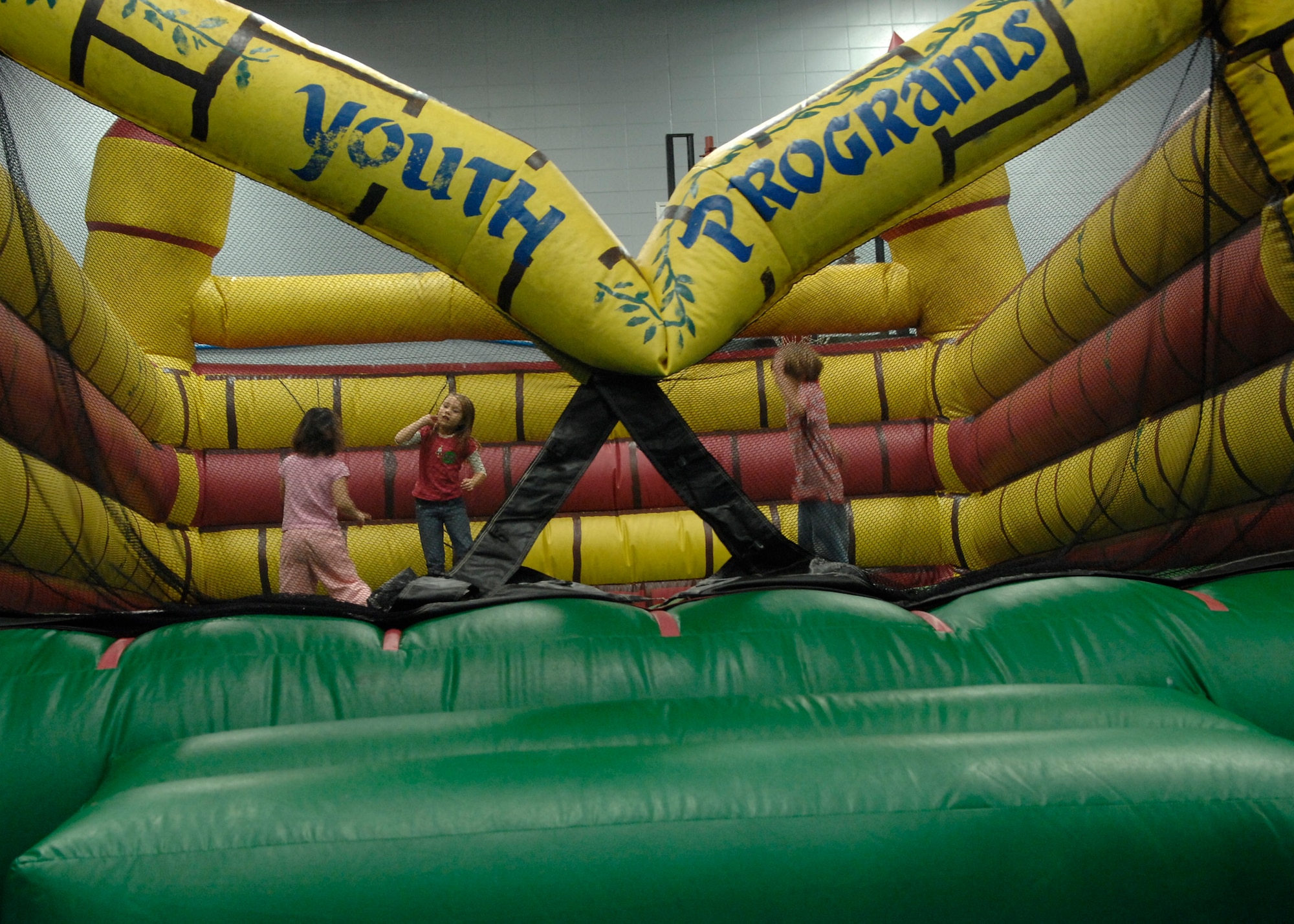 Children from Charleston AFB play in the jump castle at the holiday party Dec. 13.  Youth Programs hosts the annual holiday party where base youth have the opportunity to meet Santa Claus, get their faces painted along with various other activities. (U.S. Air Force photo/Airman 1st Class Katie Gieratz)
