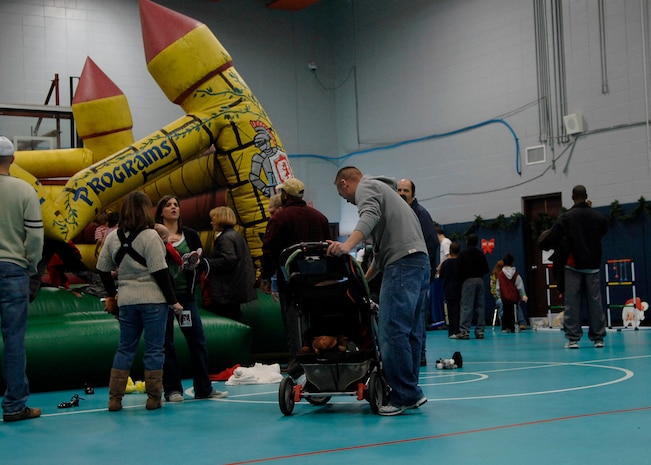 Children visit the various booths at the holiday party on Charleston AFB Dec. 13.  Youth Programs hosts the annual holiday party where base youths have the opportunity to meet Santa Claus, get their faces painted along with various other activities. (U.S. Air Force photo/Airman 1st Class Katie Gieratz)