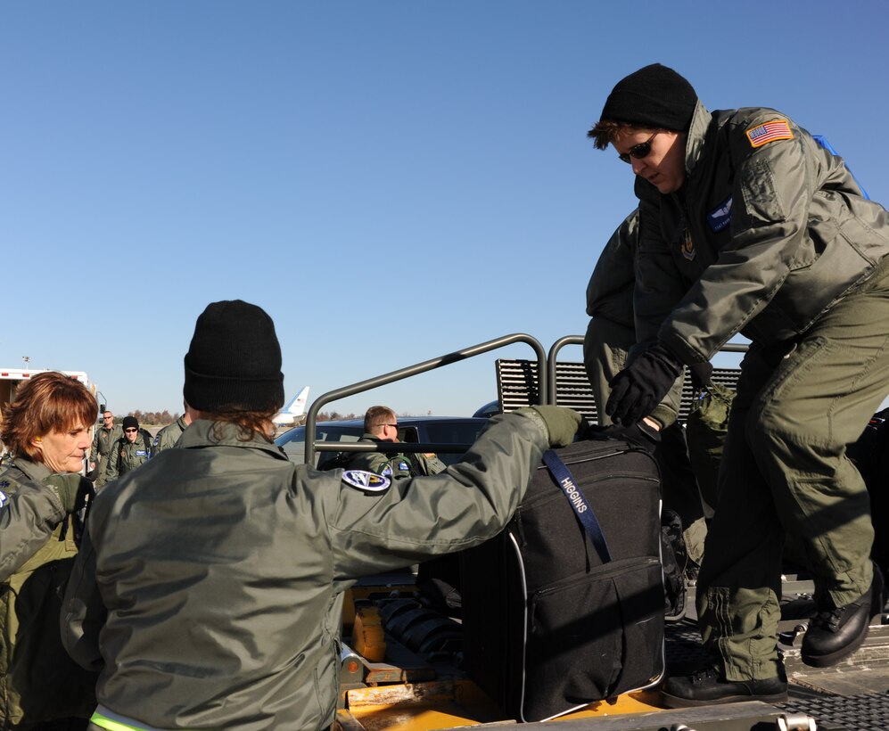 932nd Airlift Wing teamwork made a cold day go faster as these aeromedical personnel quickly loaded baggage aboard a lifting machine.  The 932nd Aeromedical Evacuation Squadron is located in the Land of Lincoln at Scott Air Force Base, Ill.  (U.S. Air Force photo/Maj. Stan Paregien)