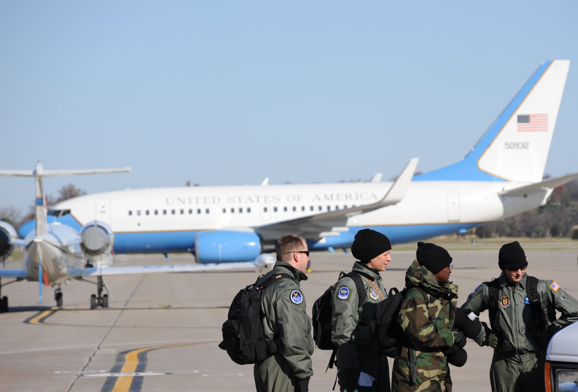 932nd Airlift Wing aeromedical staff members wait for additional equipment to arrive near the wing's C-40C (rear) at their home base, Scott Air Force Base.  They made a challenging transition from a 25 degree morning to an 80 degree afternoon as they flew from Illiniois to the U.S. Virgin Islands for additional medical training.  (U.S. Air Force photo/Maj. Stan Paregien)
