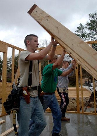 Airman 1st Class Tyler Hurt and other volunteers from Charleston AFB raise framing to make a wall for a new home while volunteering for Habitat for Humanity through the Charleston AFB First Six Dec. 11. The First Six sponsors many programs and initiatives like Habitat for Humanity to promote volunteering in local communities. Airman Hurt is with the 437th Operations Support Squadron (U.S. Air force photo/Senior Airman Timothy Taylor)
