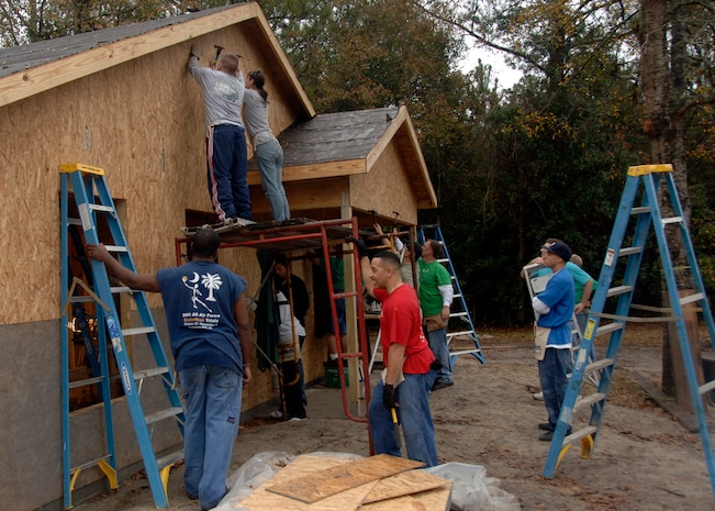 Airmen from Charleston AFB secure the siding to a house while volunteering for Habitat for Humanity through the Charleston AFB First Six  Dec. 11. The First Six sponsors many programs and initiatives like Habitat for Humanity to promote volunteering in local communities. (U.S. Air force photo/Senior Airman Timothy Taylor)


