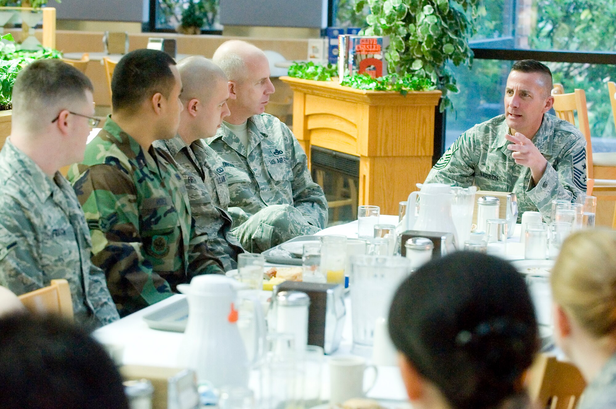 Chief Master Sgt. Joe Barron, Air Mobility Command’s command chief, right, speaks to Airmen Dec. 10 at the Olympic Dining Facility. (U.S. Air Force photo/Abner Guzman)
