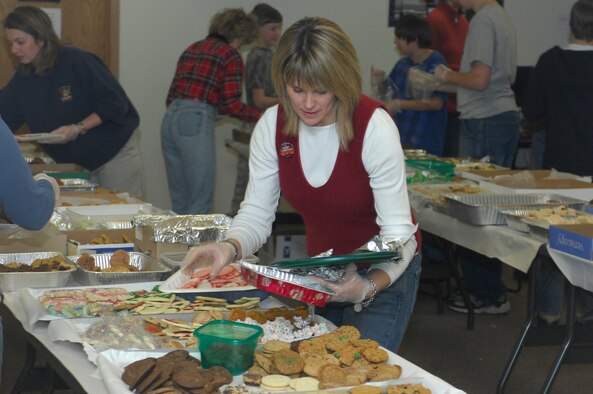 MINOT AIR FORCE BASE, N.D. -- Rebecca Sasseville, wife of Lt. Col. Andrew Sasseville, 91st Security Forces Group deputy commander, sorts cookies prior to packaging them here, Dec. 12. Members of the base community dropped off hundreds of cookies in support of the annual base cookie drive. The drive is a way to bring season’s greetings to the Airmen living in the dormitories who can’t be home for the holidays. (U.S. Air Force photo by Staff Sgt. Keith Ballard)
