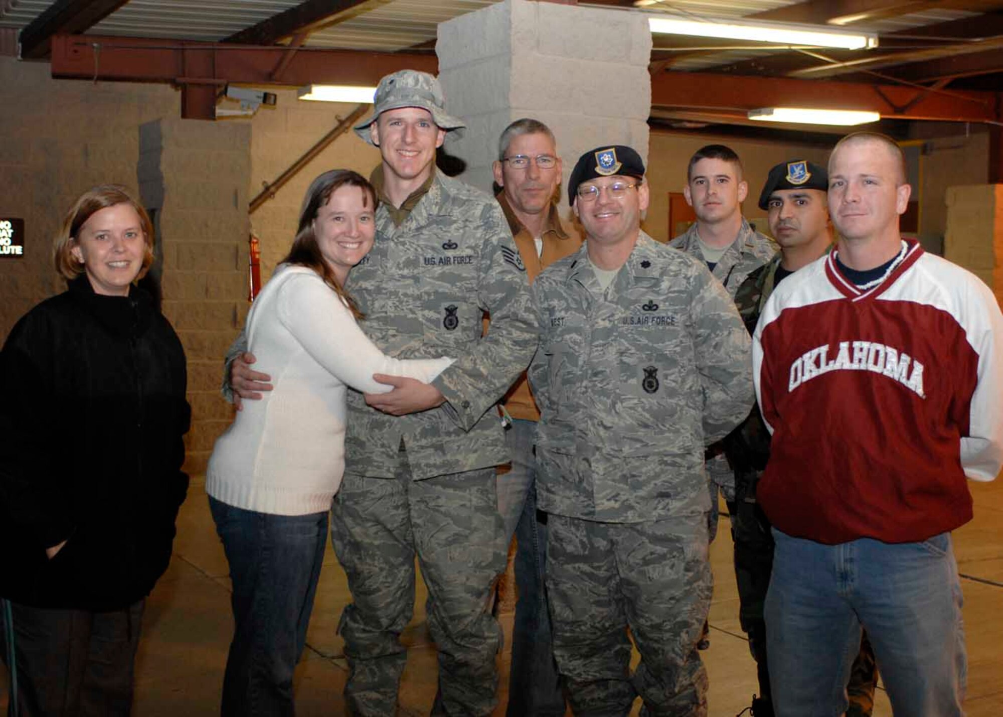 Lt. Col. John West, 49th Security Forces commander and Master Sgt Cindy McKee, 49 SFS first sergeant, pose for a photo with returning deployer Staff Sgt. Christopher Spradley, also 49 SFS, at Holloman Air Force Base, N.M., Dec.13. Sergeant Spradley was deployed for five and a half months to Camp Thji, Iraq with his military working dog. (U.S. Air Force photo/Airman 1st Class Rachel A. Kocin)