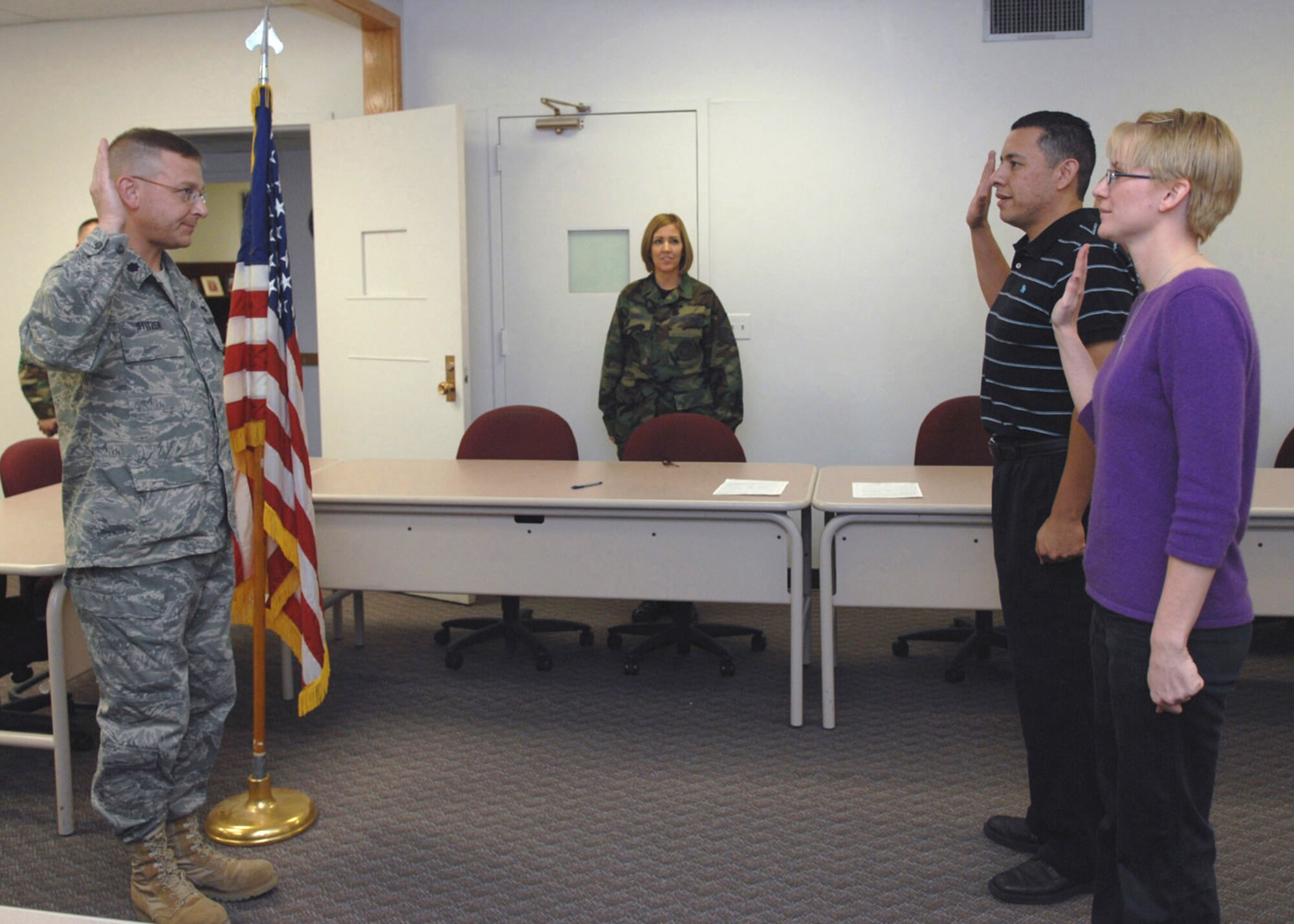 Airman 1st Class Terri Cowan and Senior Airman Jay Tarango Jr. take the oath of enlistment during the re-enlistment ceremony at Holloman Air Force Base, N.M., Dec. 3. These Airmen were the first two reserve enlistments into the 301st Fighter Wing, Detachment 1. (U.S. Air Force photo/Airman 1st Class Veronica Salgado)