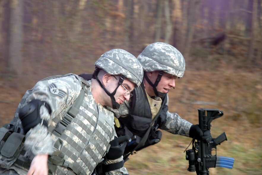 A student in the U.S. Air Force Expeditionary Center's Phoenix Warrior Training Course move an "injured Airman" during a scenario for convoy operations training in the course Dec. 5, 2008, on a Fort Dix, N.J., range.  The course is taught by the Center's 421st Combat Training Squadron and prepares security forces Airmen for upcoming deployments. (U.S. Air Force Photo/Staff Sgt. Paul R. Evans)